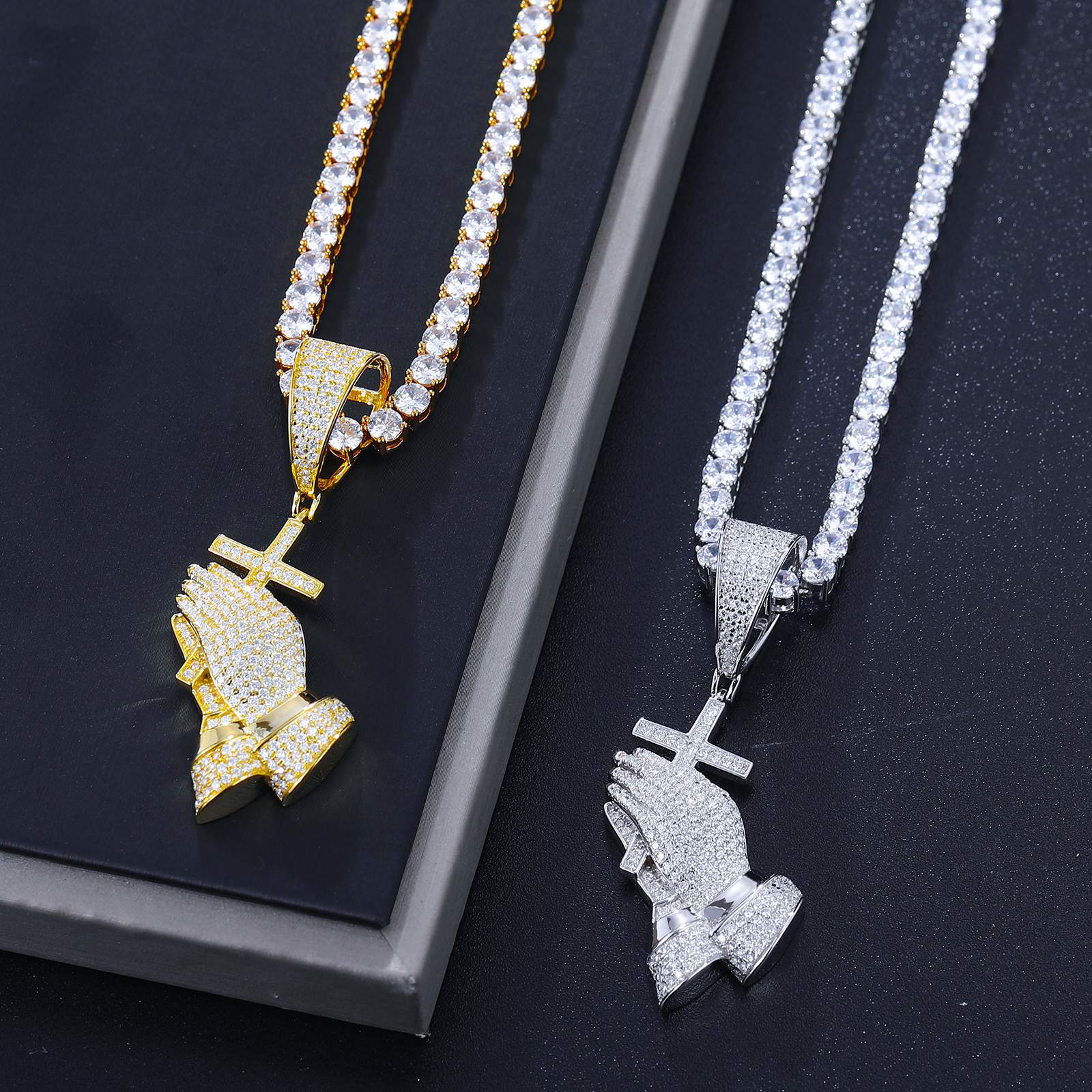 Art-directed comparison: White gold & gold pray hands leaning on marble - 42 VVS moissanites per piece | ISO 9227 tarnish-proof certification