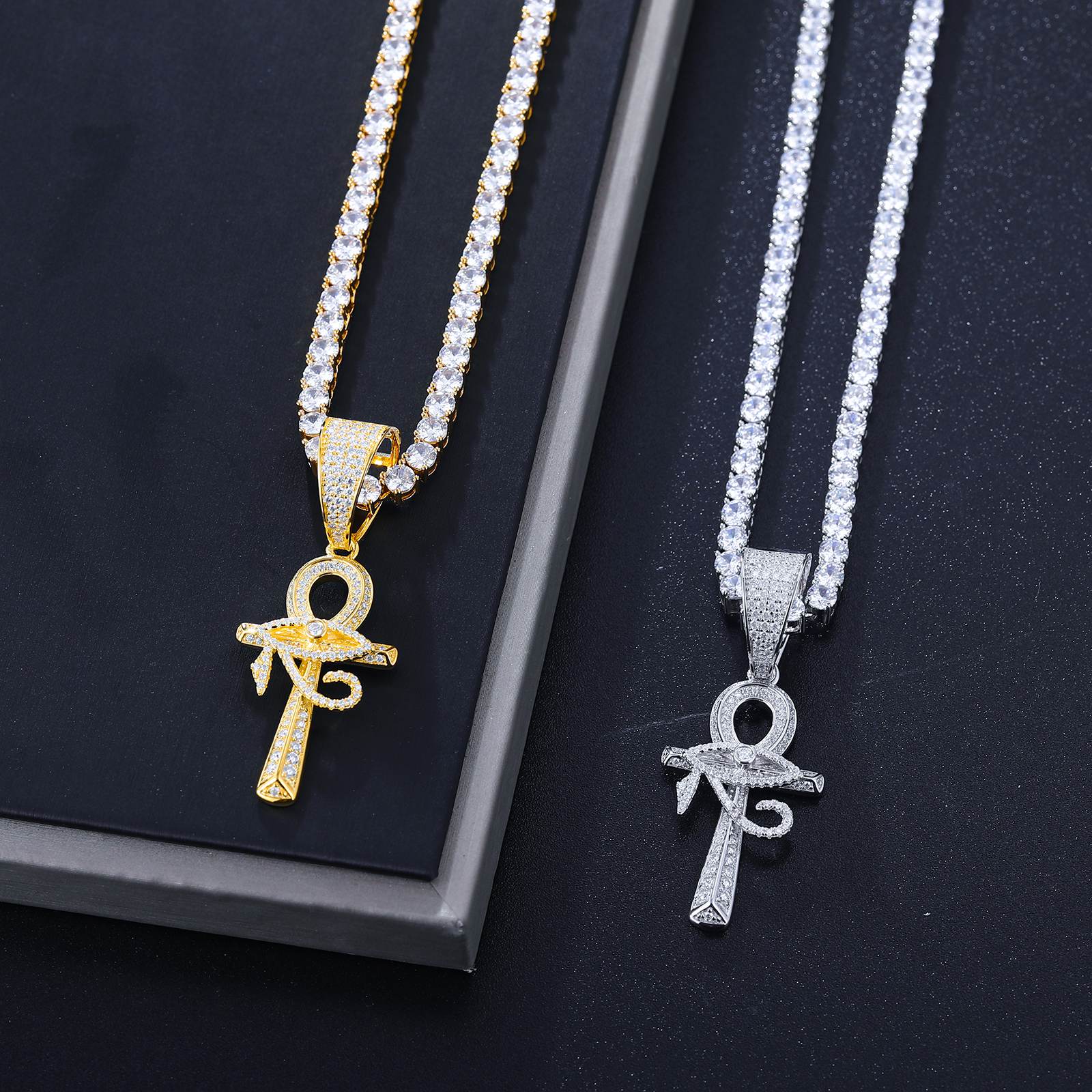 Side-by-side white gold & gold evil eye ankhs - identical 58 VVS moissanites per piece | ISO 9227 tarnish-proof certification visible