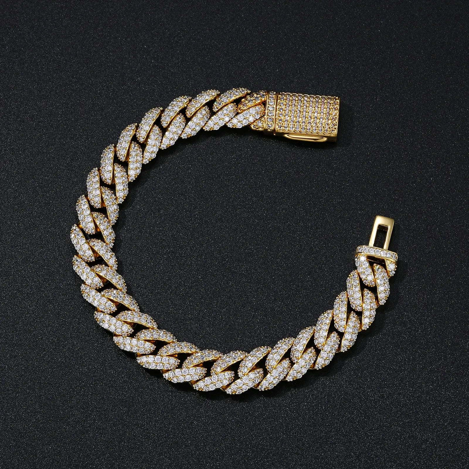 Yellow gold Cuban link bracelet with CZ stones elegantly displayed on black desktop, showcasing luxury men's jewelry and premium packaging.