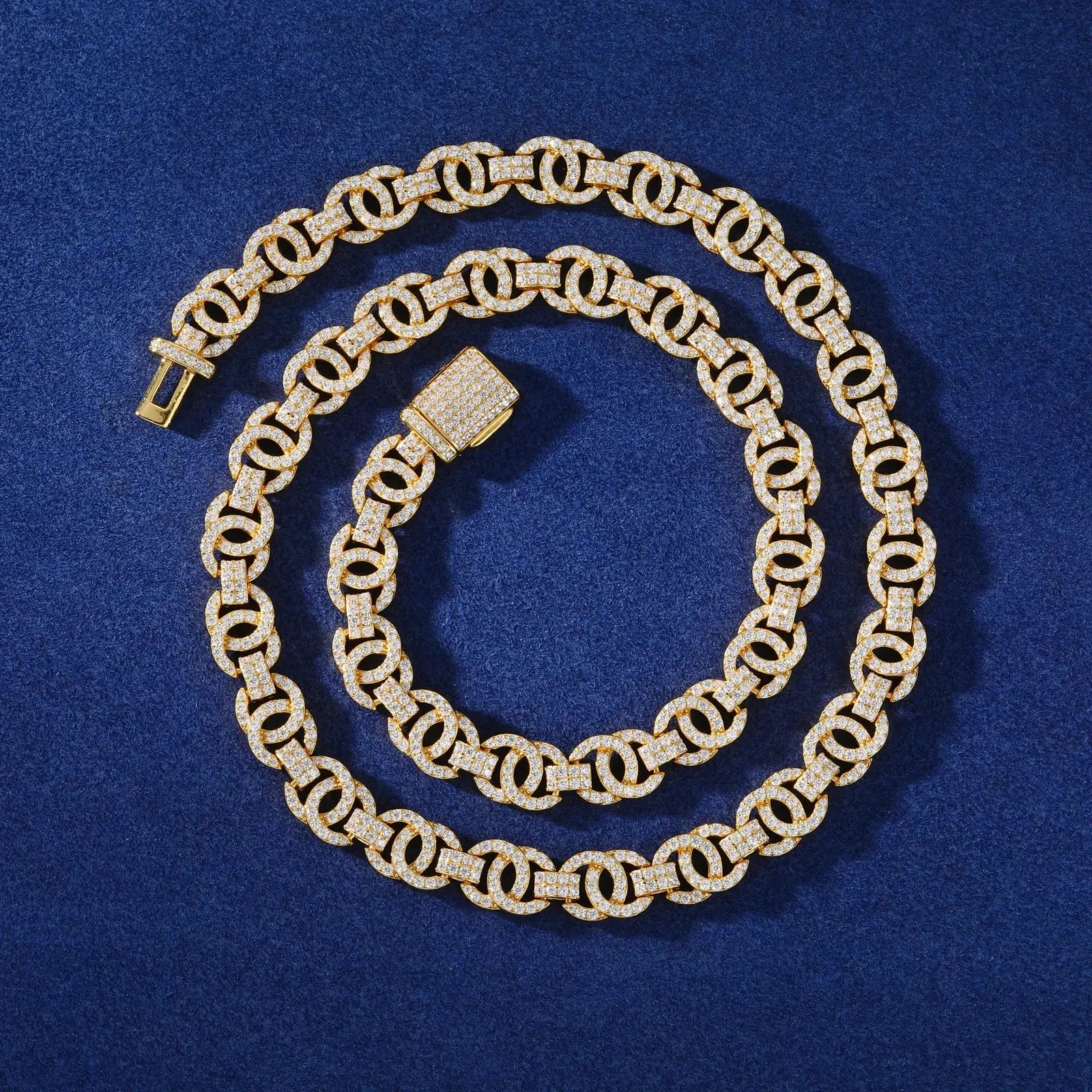 Circular arrangement of gold plated 10mm Chanel link chain on blue velvet - luxury jewelry gift presentation with moissanite accents