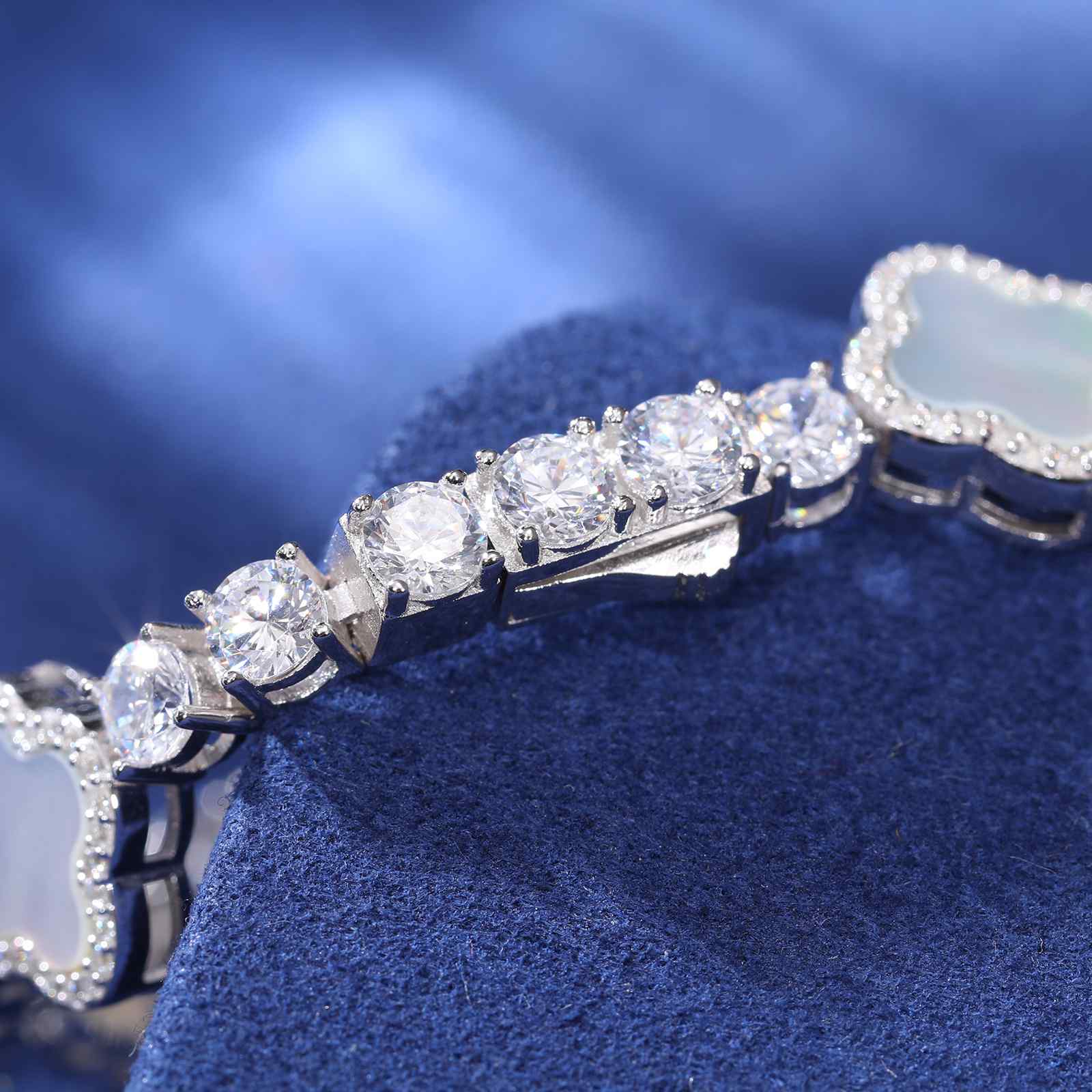 Secure S925 silver clasp on white enamel four-leaf clover bracelet, engraved for authenticity and tarnish-resistant durability.
