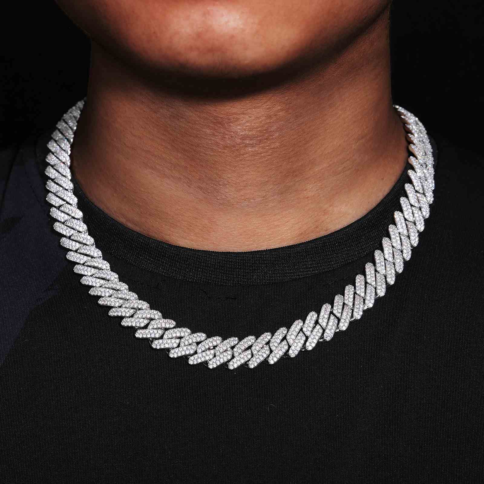 Unisex styling: Model wearing the 14mm CZ Diamond Prong Cuban Link Chain as a statement necklace, paired with a black turtleneck for a luxury look