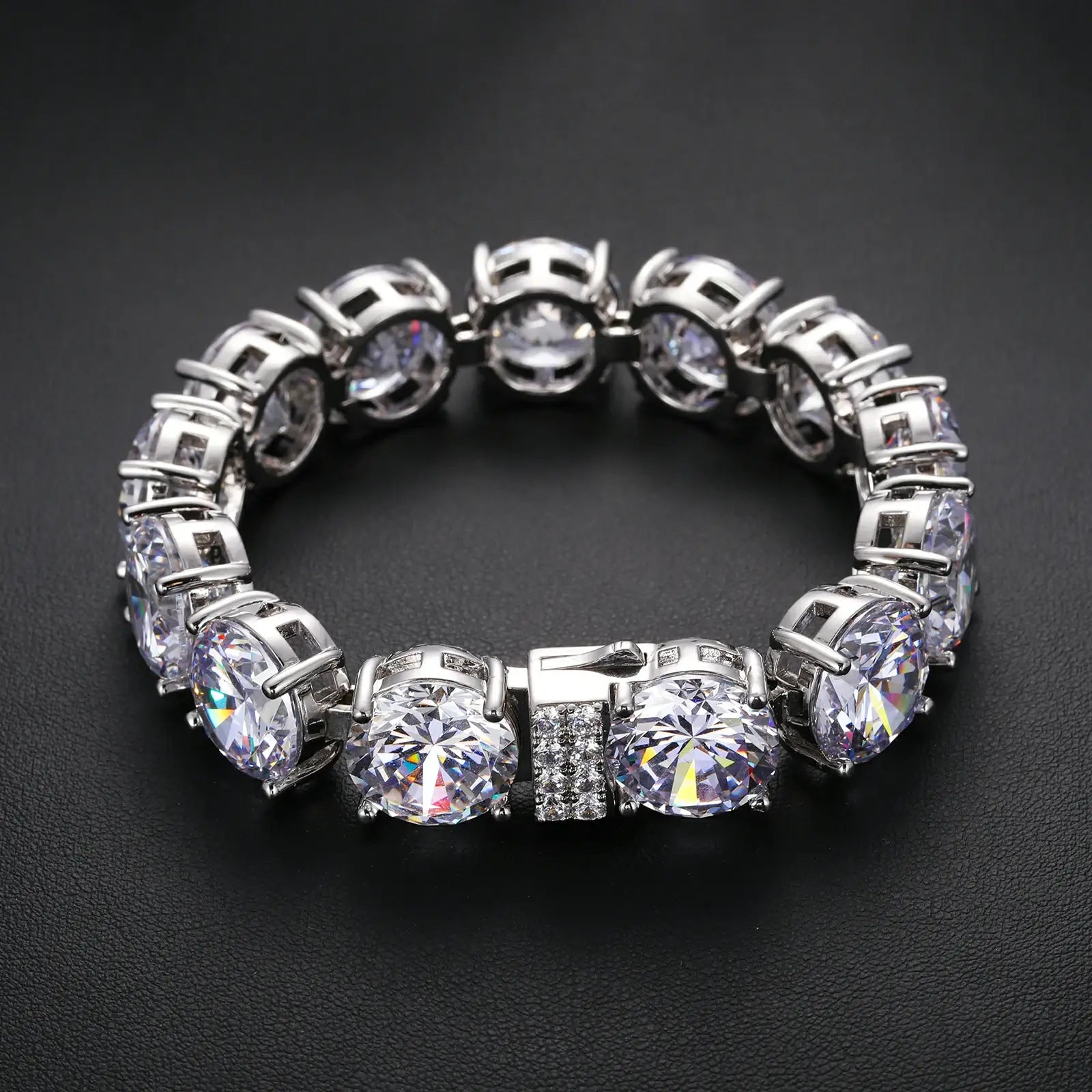15mm white gold moissanite tennis bracelet displayed on black table - oversized statement jewelry with brilliant stone reflection