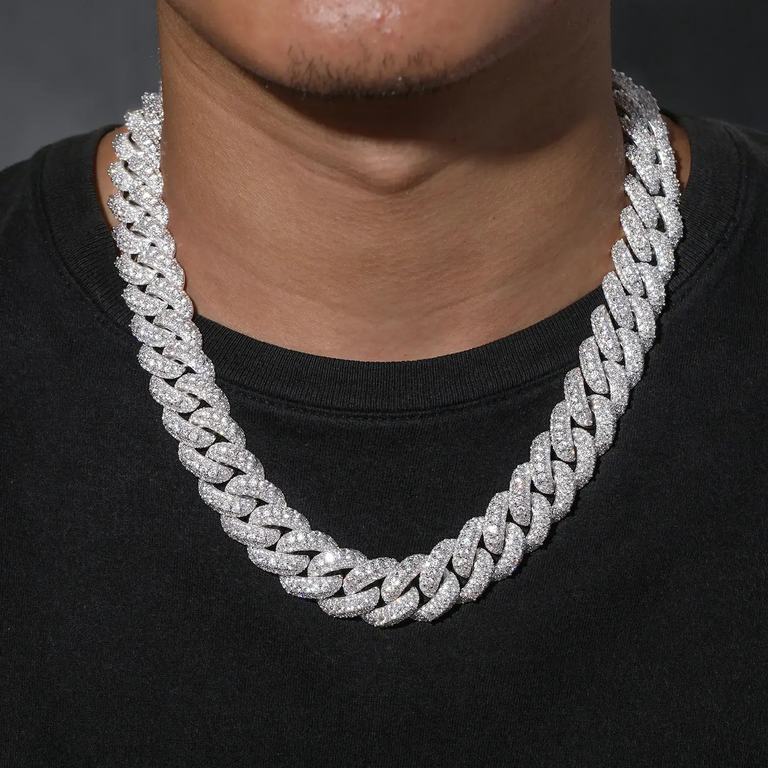 Men’s 18mm white gold 3-row moissanite Cuban link chain worn by model in urban setting, showcasing versatility for daily wear or special occasions.