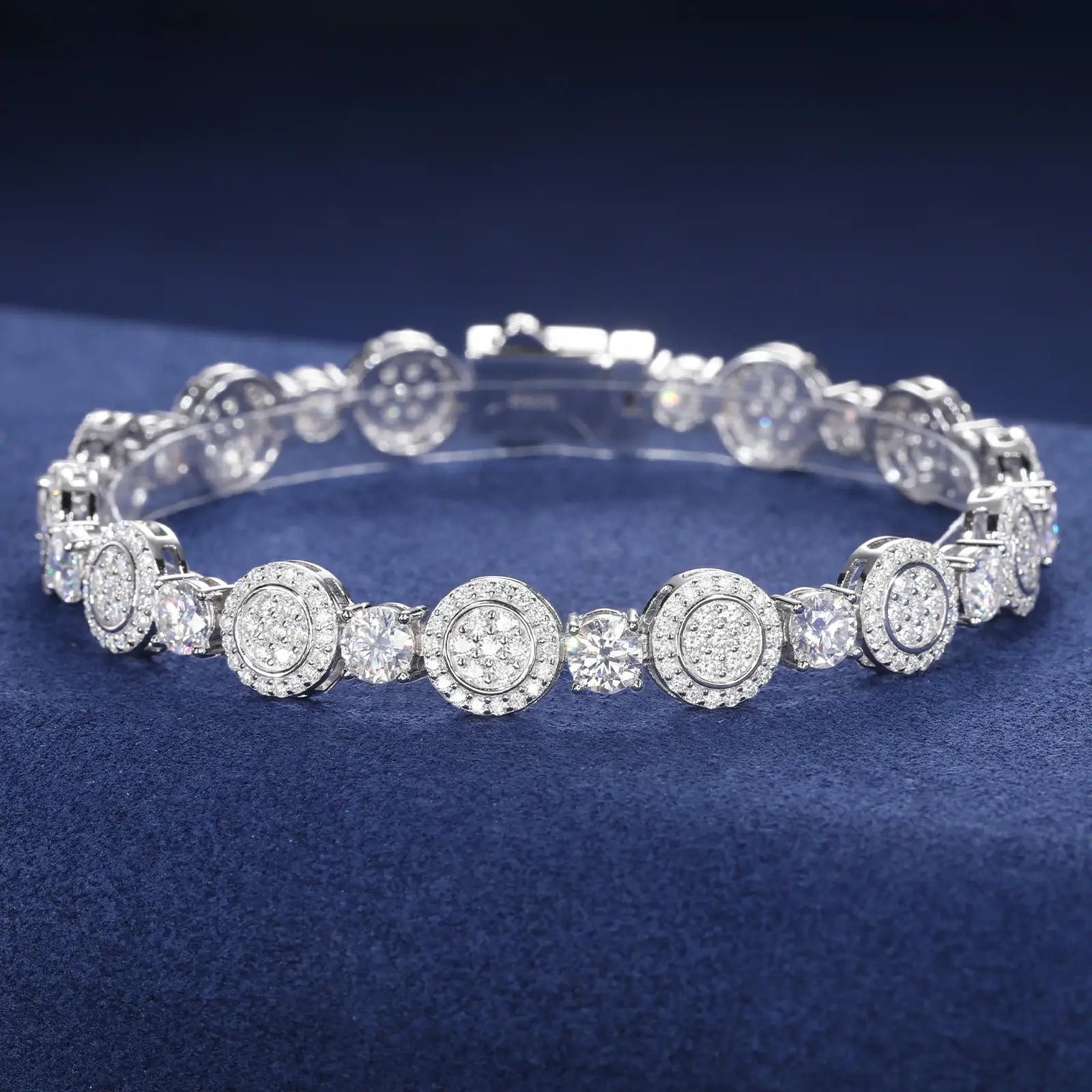 Close-up of 9mm white gold 925 sterling silver moissanite concentric circles tennis bracelet chain on blue table — highlighting moissanite detailing
