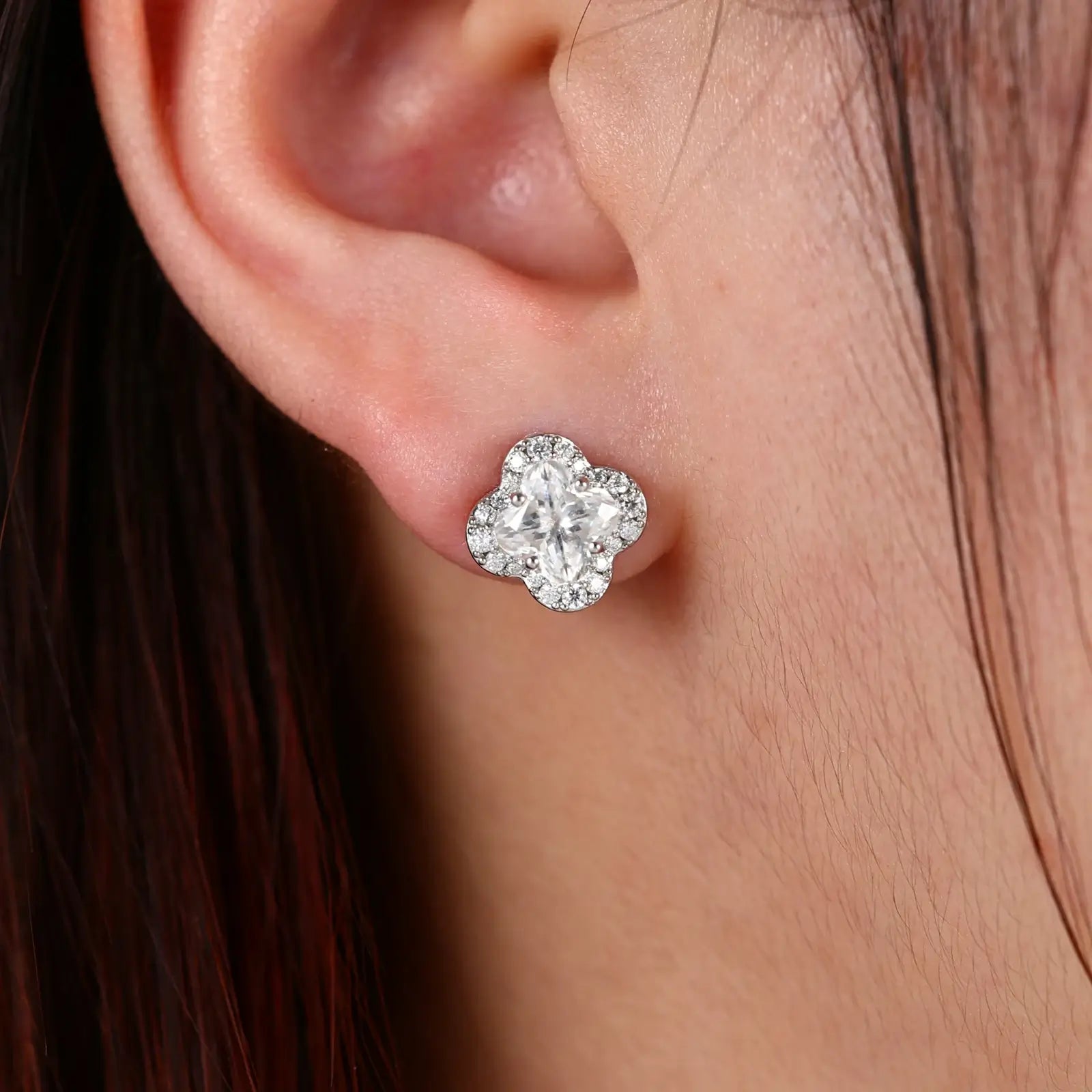 Female model wearing white gold 925 sterling silver lily cut moissanite four leaf clover stud earrings — hypoallergenic 925 silver, elegant lucky motif, moissanite detail for refined daily wear