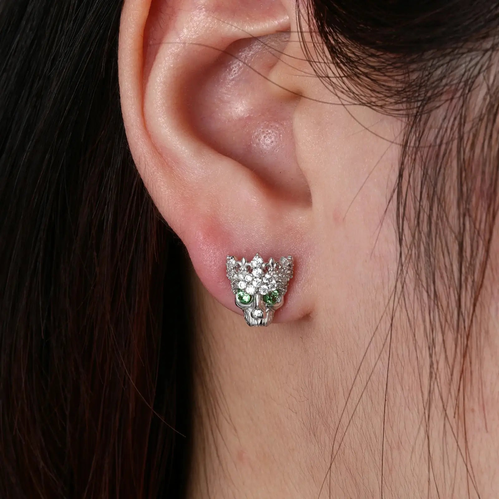 Female model wearing white gold 925 sterling silver moissanite Chrome Hearts crown skull stud earrings — hypoallergenic 925 silver, gothic-luxury crown-skull motif, moissanite & zircon detail for bold daily style