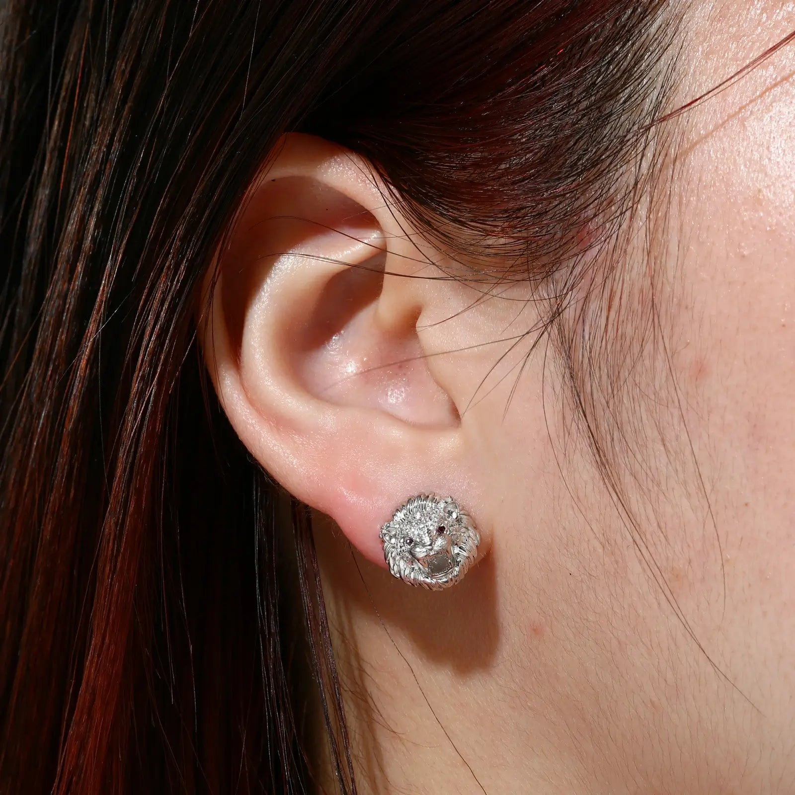 Female model wearing white gold 925 sterling silver moissanite little lion stud earrings — tarnish-resistant 925 silver, sleek white gold tone, moissanite detail for fierce fashion
