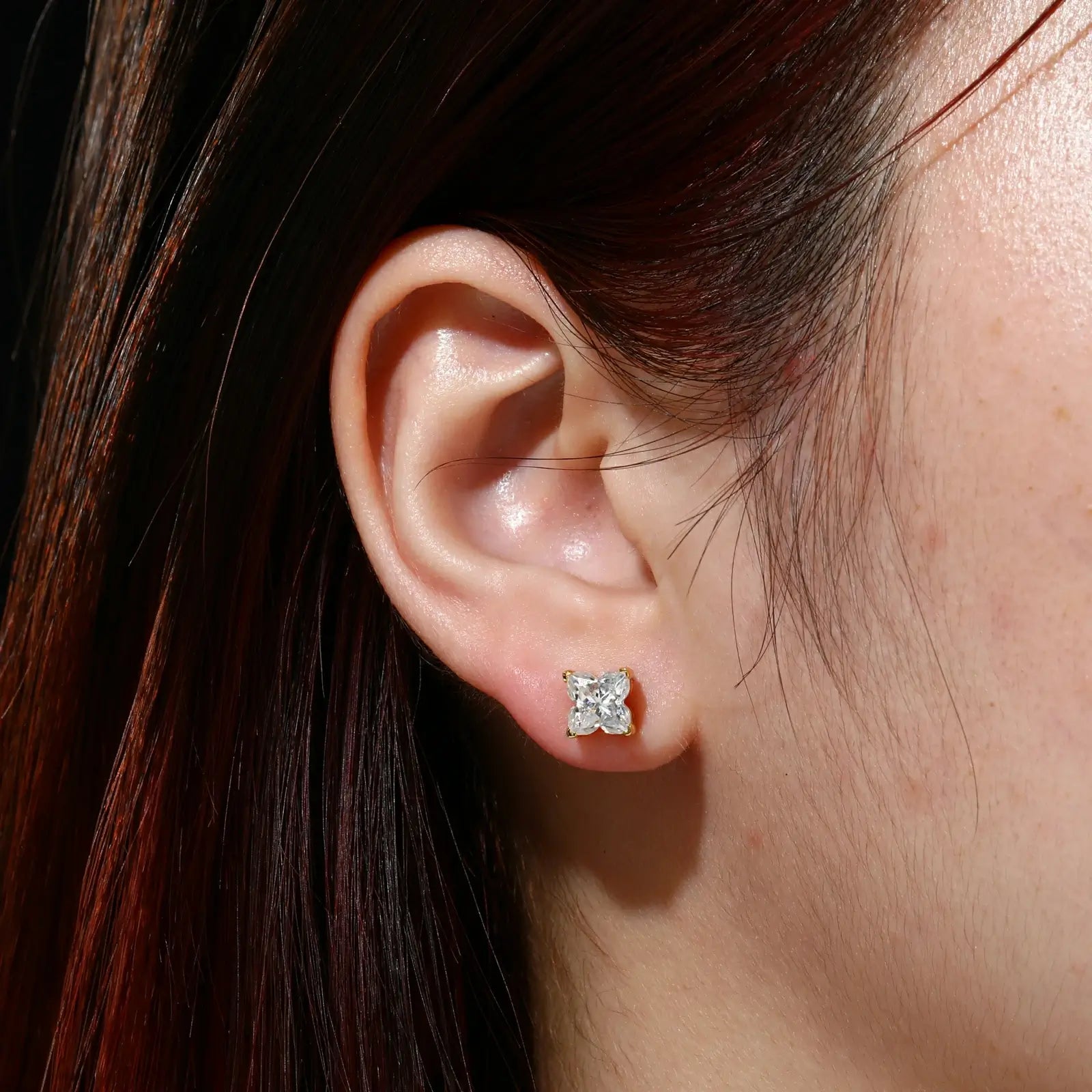 Female model wearing yellow gold 925 sterling silver lily cut moissanite stud earrings — tarnish-resistant 925 silver, warm gold tone, lily-cut moissanite for sophisticated glamour