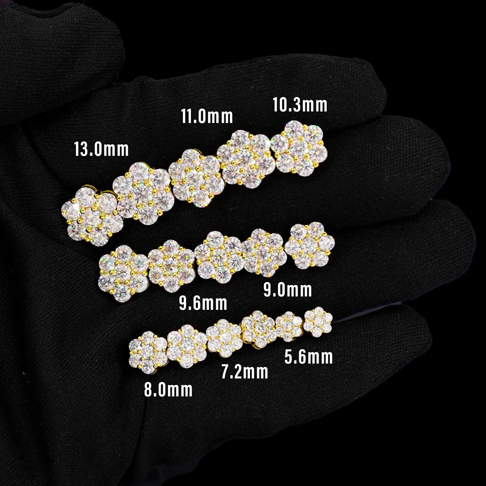 Gold 925 sterling silver floral 7-stone earrings multi-size options on black gloves — highlights size variety, moissanite brilliance, 925 silver durability
