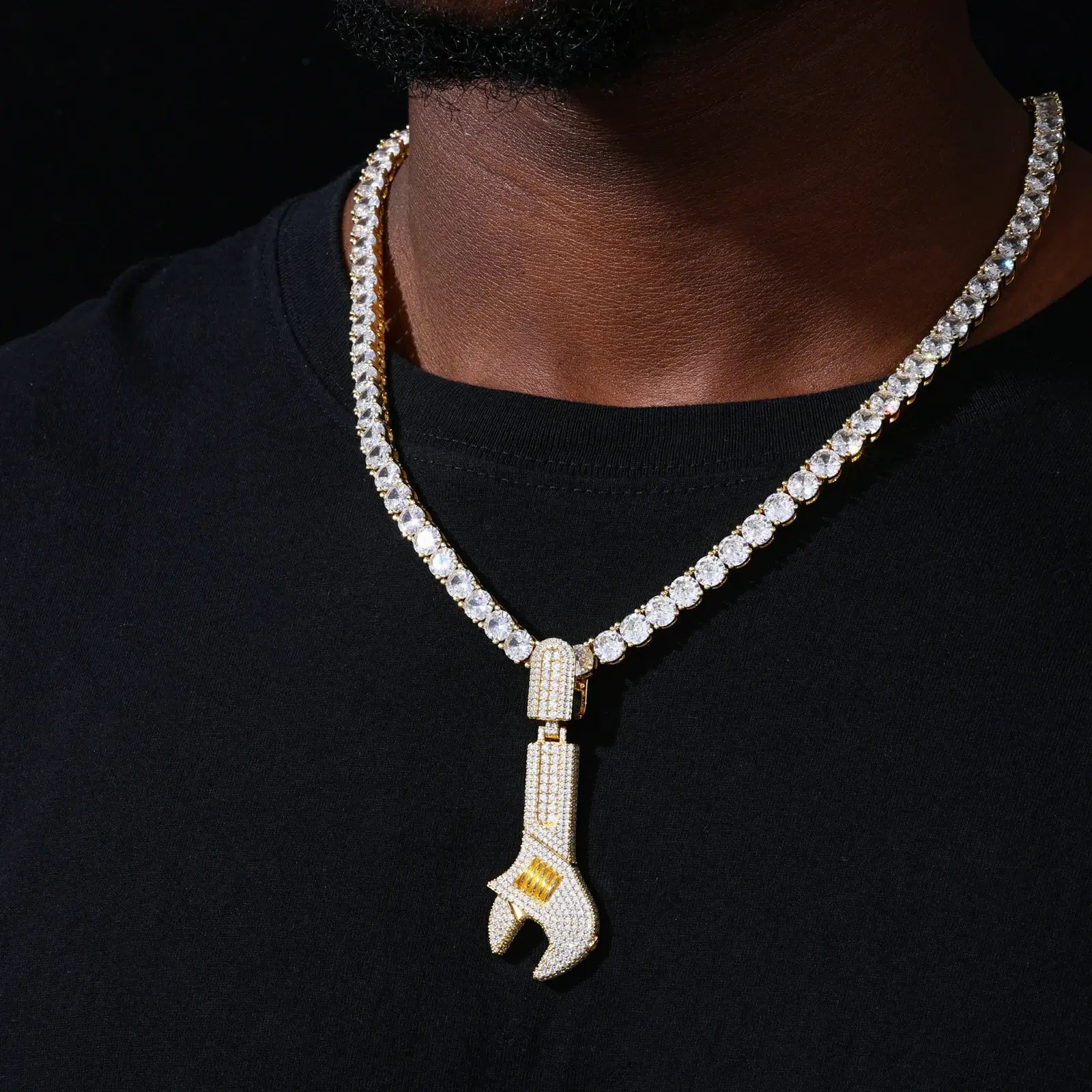 Gold 925 sterling silver moissanite wrench pendant worn on black outfit — gold-tone 925 silver, full moissanite, bold hip-hop look, industrial luxury style