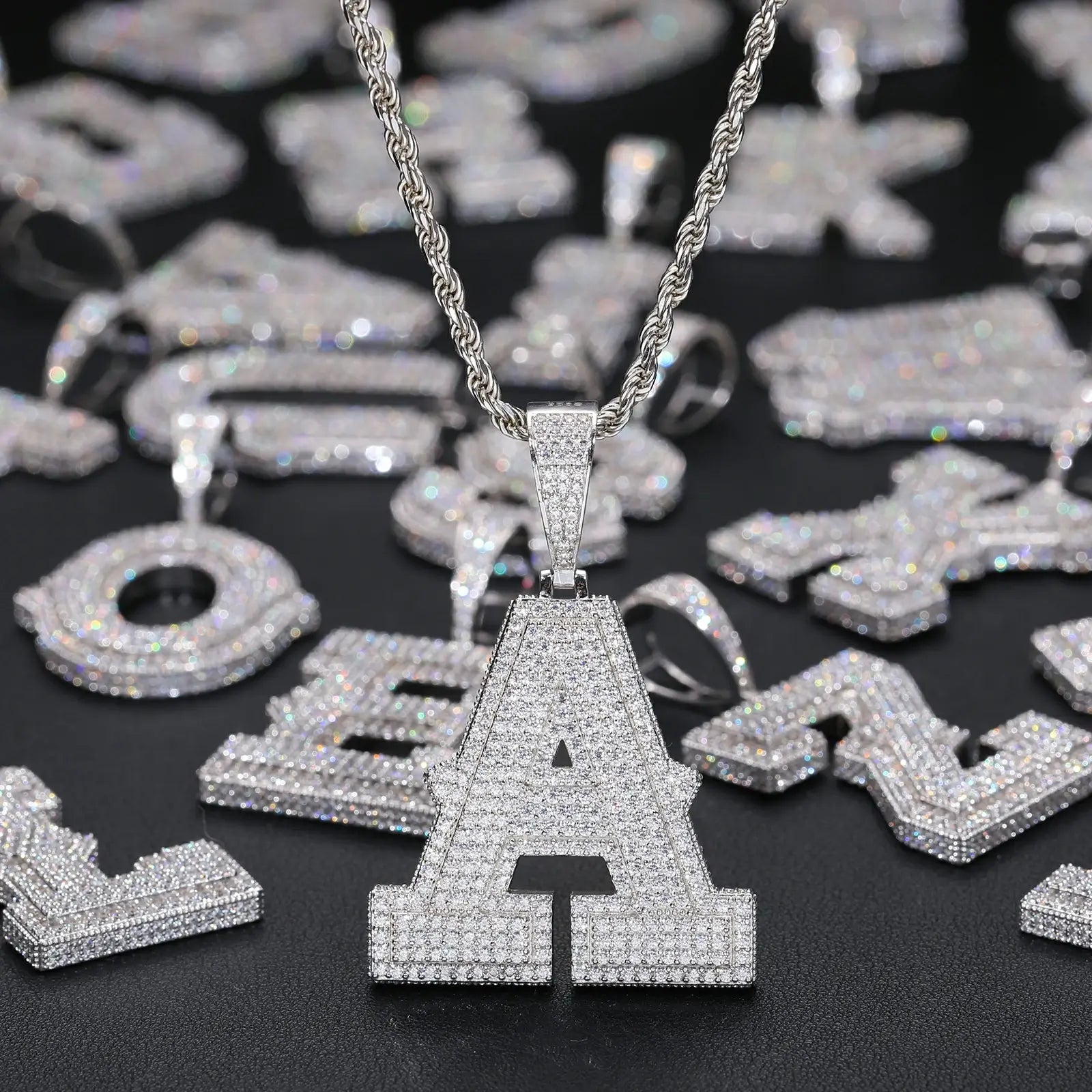 Hanging white gold 925 sterling silver moissanite initial letter pendant with other letters in background — bling personalized jewelry