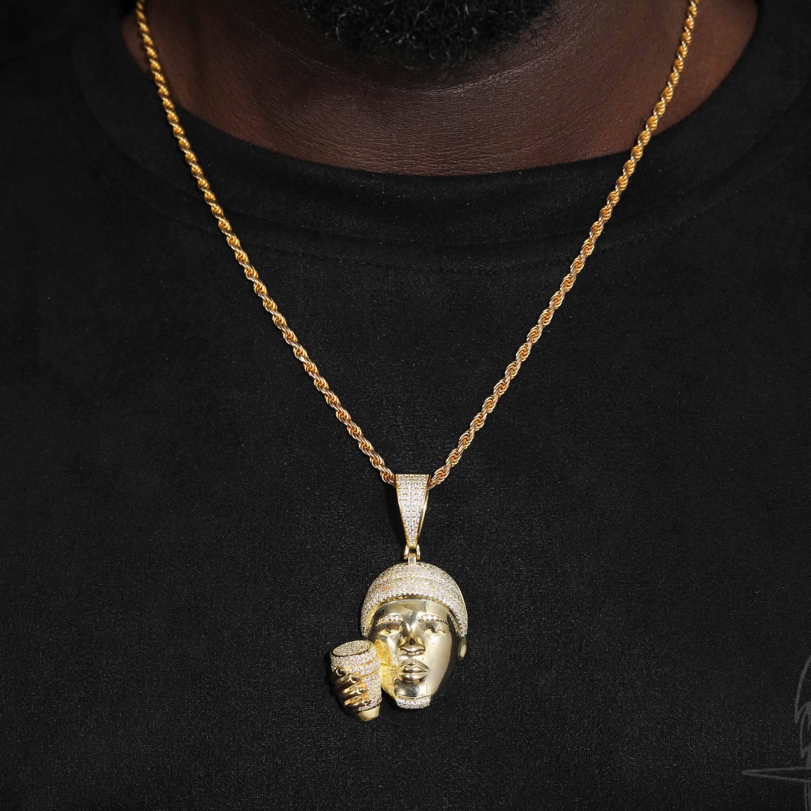 Stylish man wearing gold-tone rapper head cup necklace on twisted chain - Urban fashion inspiration with hypoallergenic silver