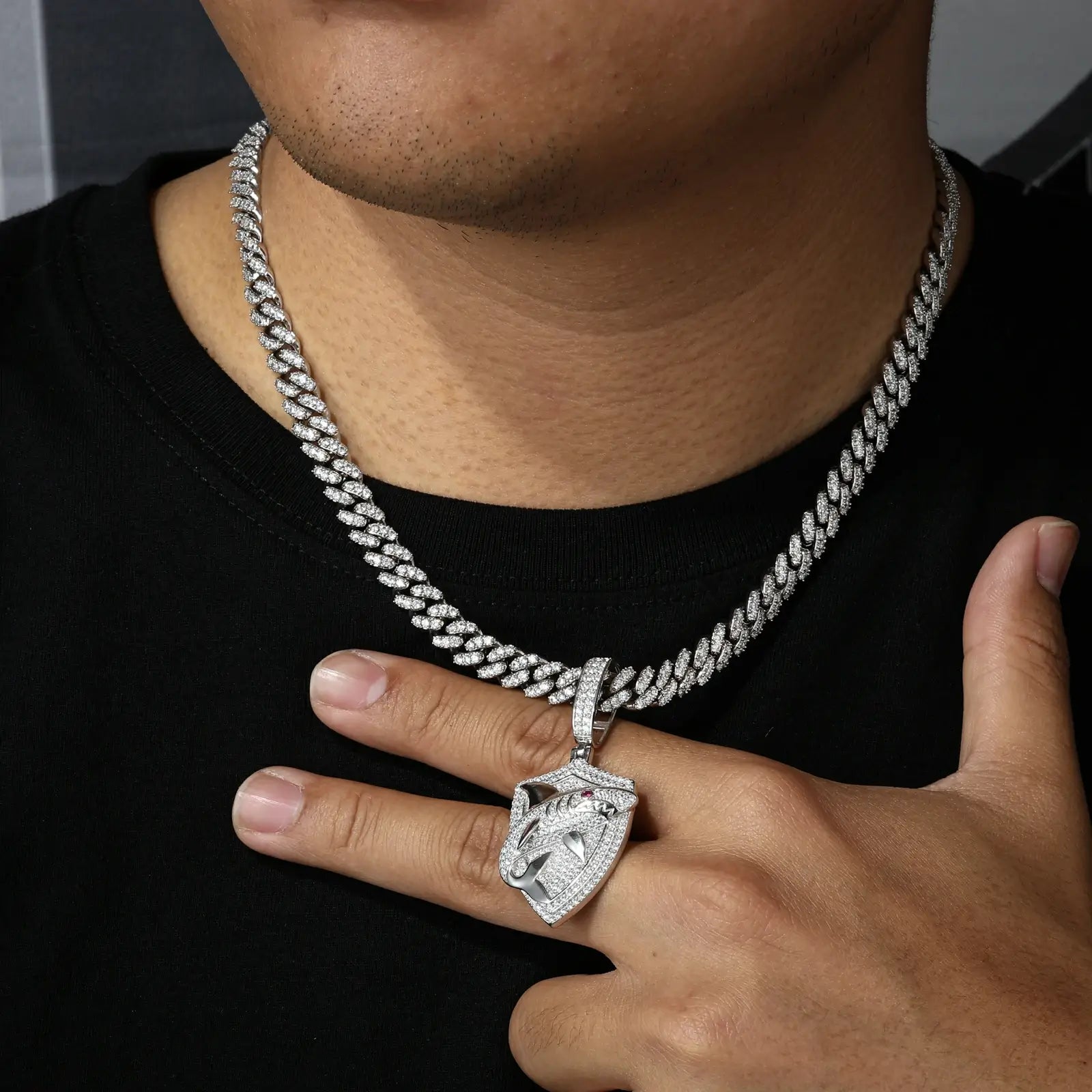 Male model wearing white gold 925 sterling silver moissanite shark shield pendant with white cuban chain — men’s hypoallergenic trendy luxury jewelry