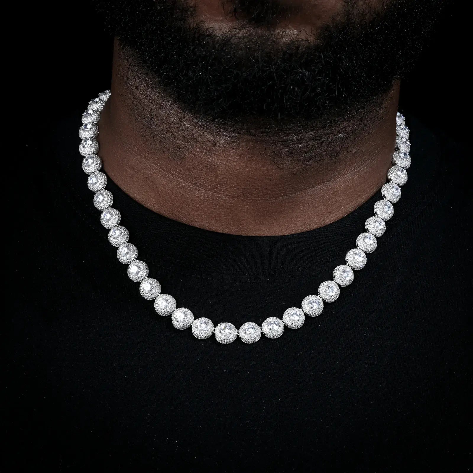 Male model wearing white gold 10mm 925 sterling silver moissanite round halo tennis chain in casual style — highlights full moissanite sparkle, everyday luxury, tarnish-resistant 925 silver