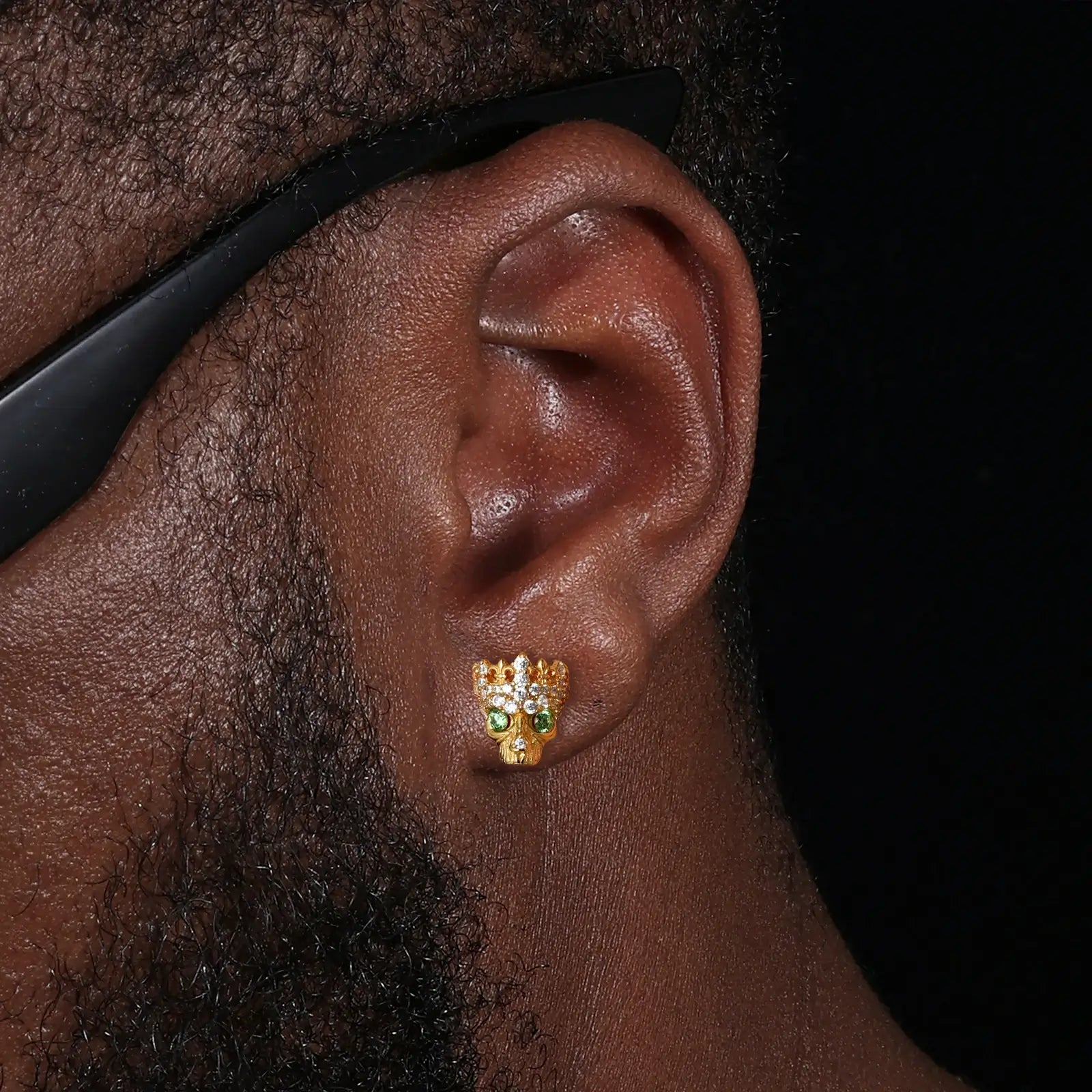 Male model wearing yellow gold 925 sterling silver moissanite Chrome Hearts crown skull stud earrings — tarnish-resistant 925 silver, rebel-luxury crown-skull design, moissanite & zircon for edgy masculine glamour