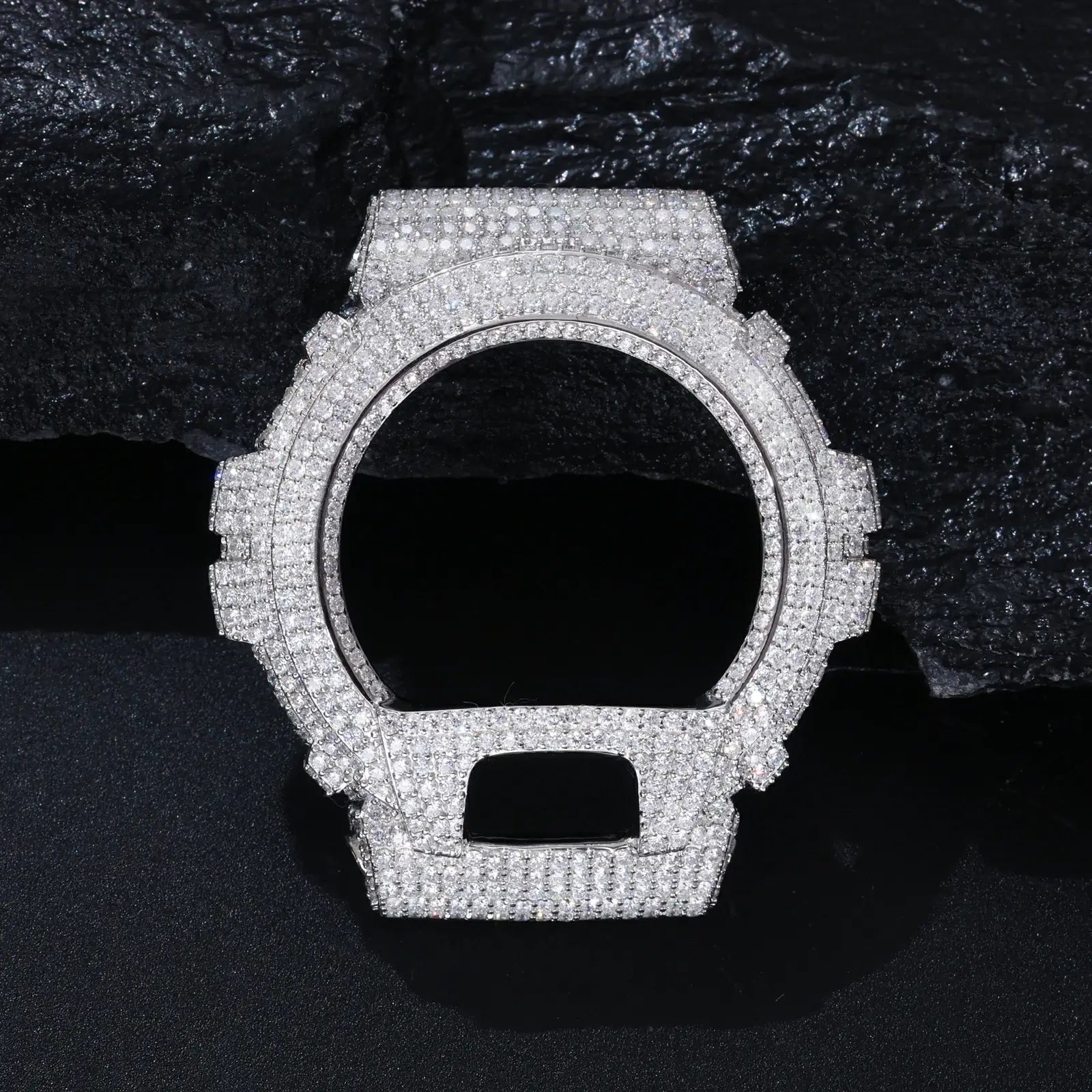 White gold 925 sterling silver moissanite G-Shock DW6900 watch case displayed on black rock — merges streetwear heritage with luxury, hypoallergenic 925 silver, moissanite brilliance