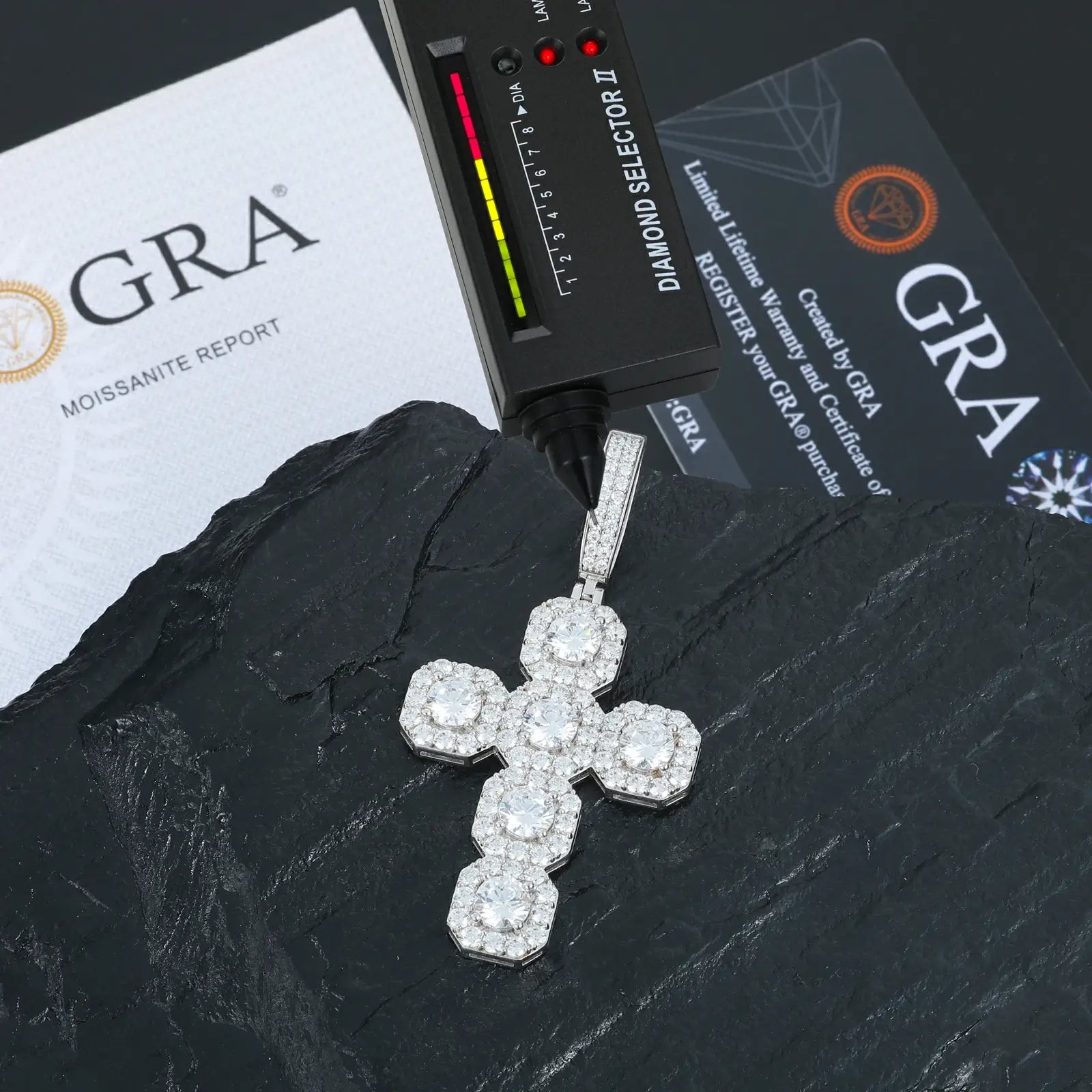 White gold 925 sterling silver moissanite square halo cross pendant with diamond tester + GRA certificate on black table — certified moissanite, 925 silver durability, square halo cross design