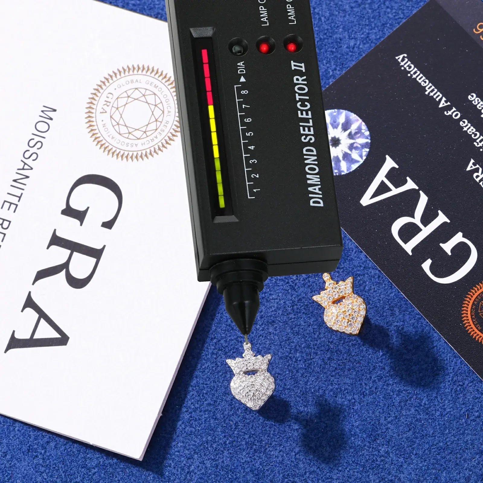 White & yellow gold 925 sterling silver moissanite crown heart stud earrings with diamond tester + GRA certificate on blue table — certified moissanite, 925 silver durability, regal crown-heart design