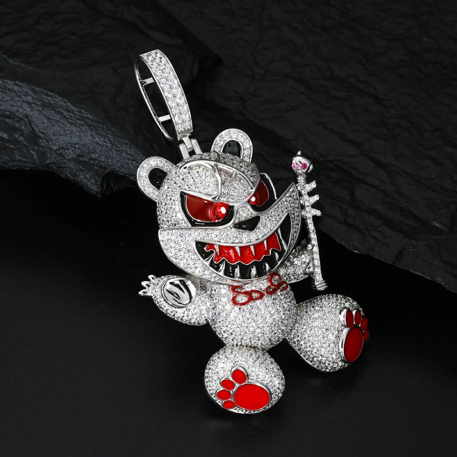 Side view of yellow gold 925 sterling silver moissanite evil bear pendant on black table — highlighting scepter, red accents, 3D design