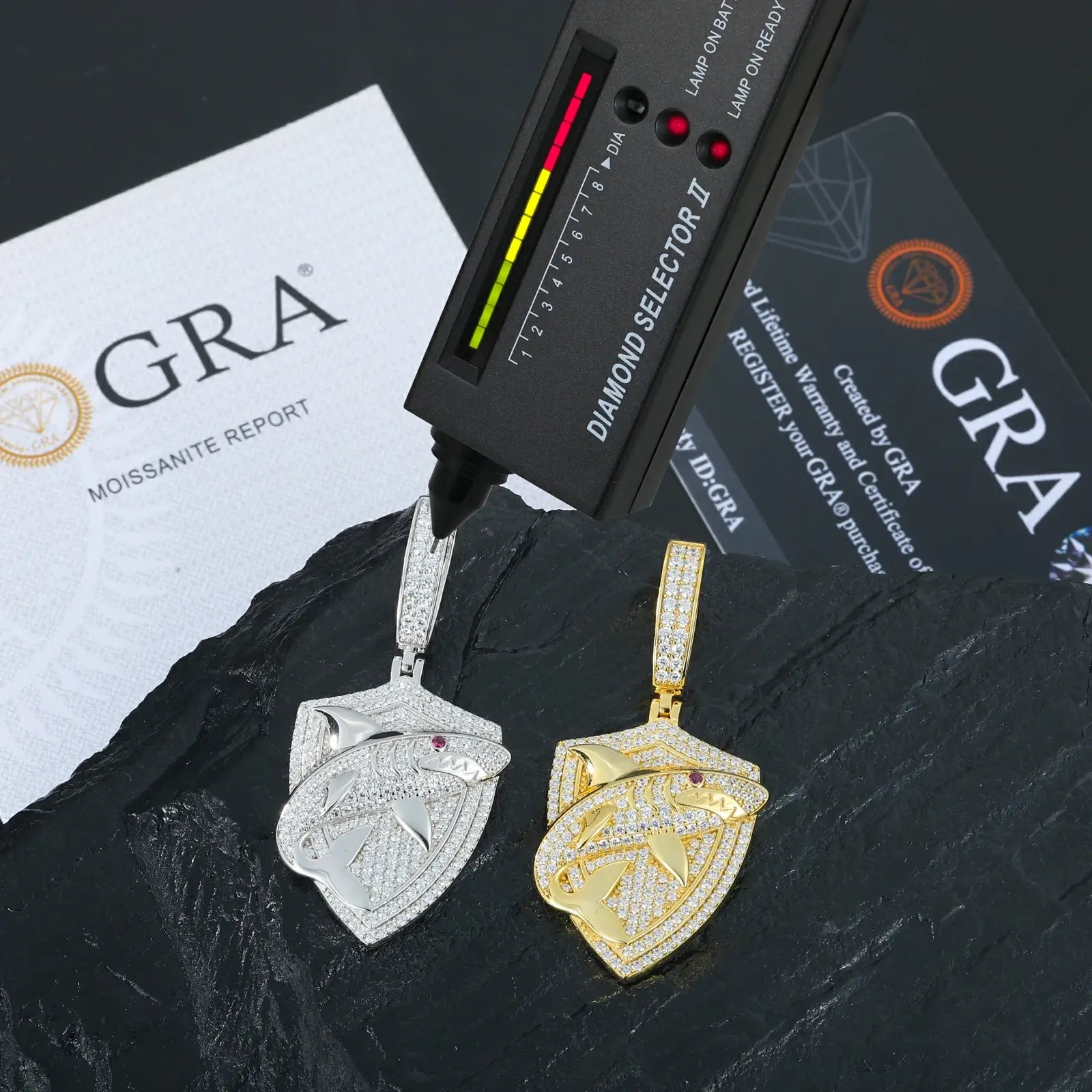 Yellow & white gold 925 sterling silver moissanite shark shield pendants with diamond tester + GRA certificate on black table — certified moissanite jewelry