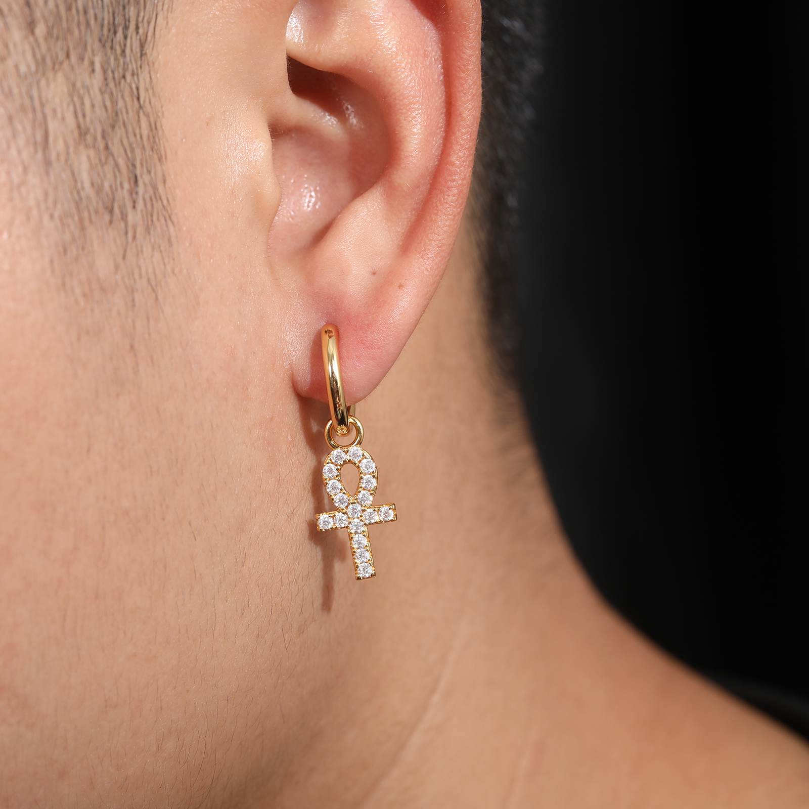 a man wear a ankh cross earrings