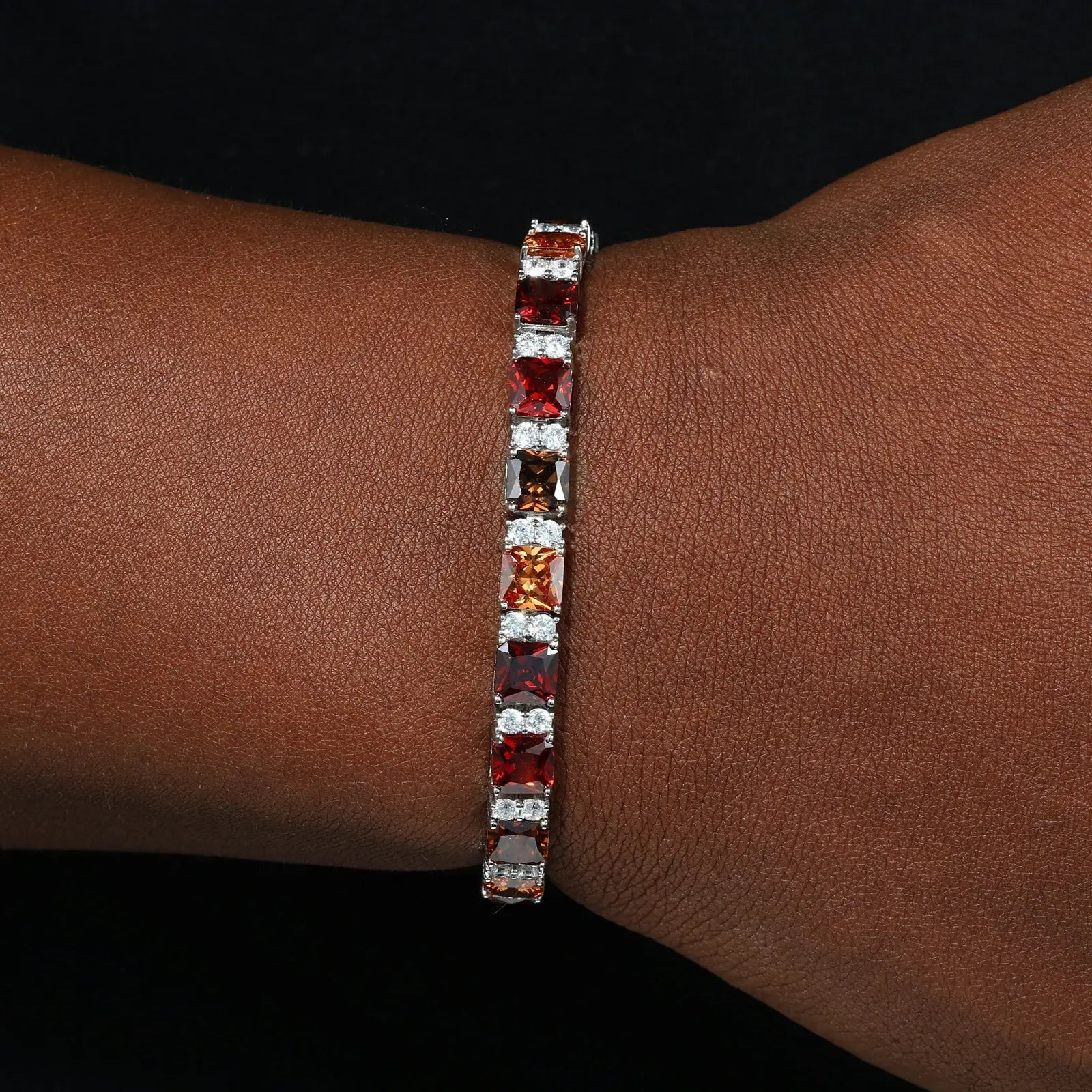 Black male model styling 7mm white gold gradient tennis bracelet - Asscher cut moissanite stones transitioning mocha to cognac | Men's luxury stackable jewelry