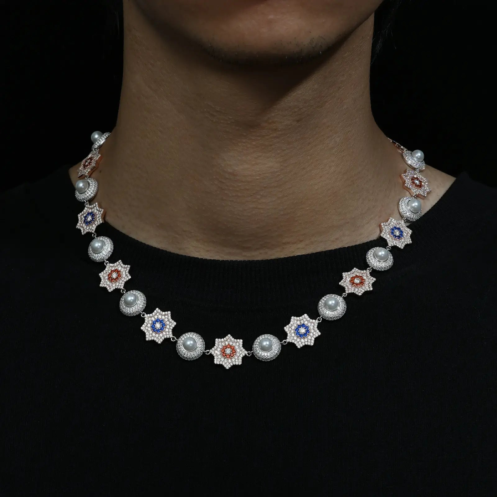 Black male model wearing 17mm white gold 925 silver moissanite sun and pearl halo link chain necklace - showcasing the exquisite design and luxury for modern men's fashion