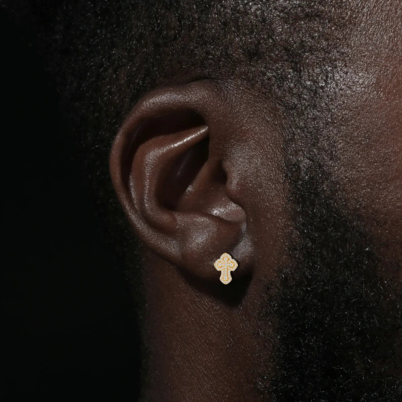 African American man modeling gold iris cross earrings - deep skin tone contrasting moissanite flashes | Boardroom-to-gala hypoallergenic elegance