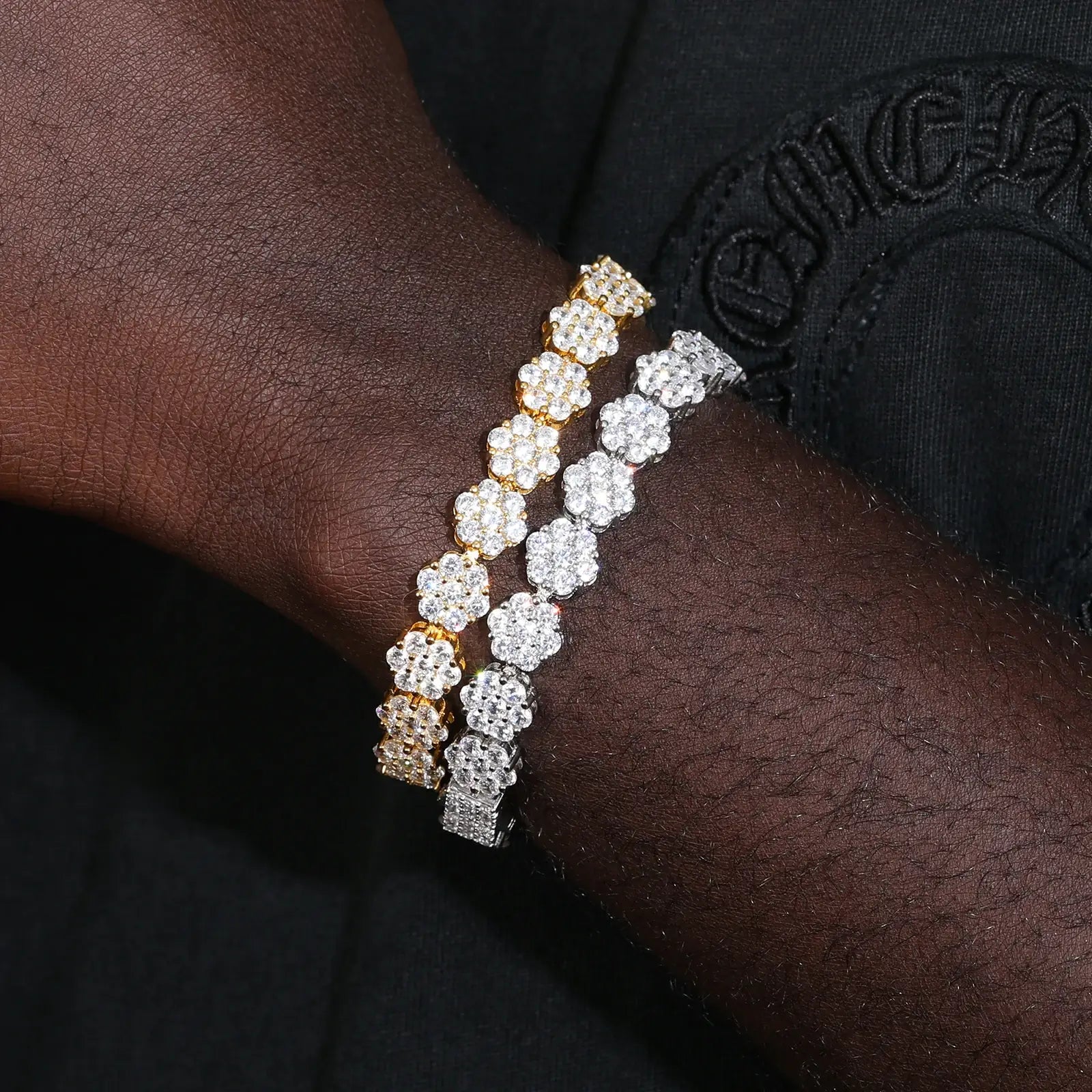 Black woman modeling both white gold & yellow gold 9mm flower tennis bracelets - S925 silver moissanite clusters contrasting dark skin | Hypoallergenic stacking glam