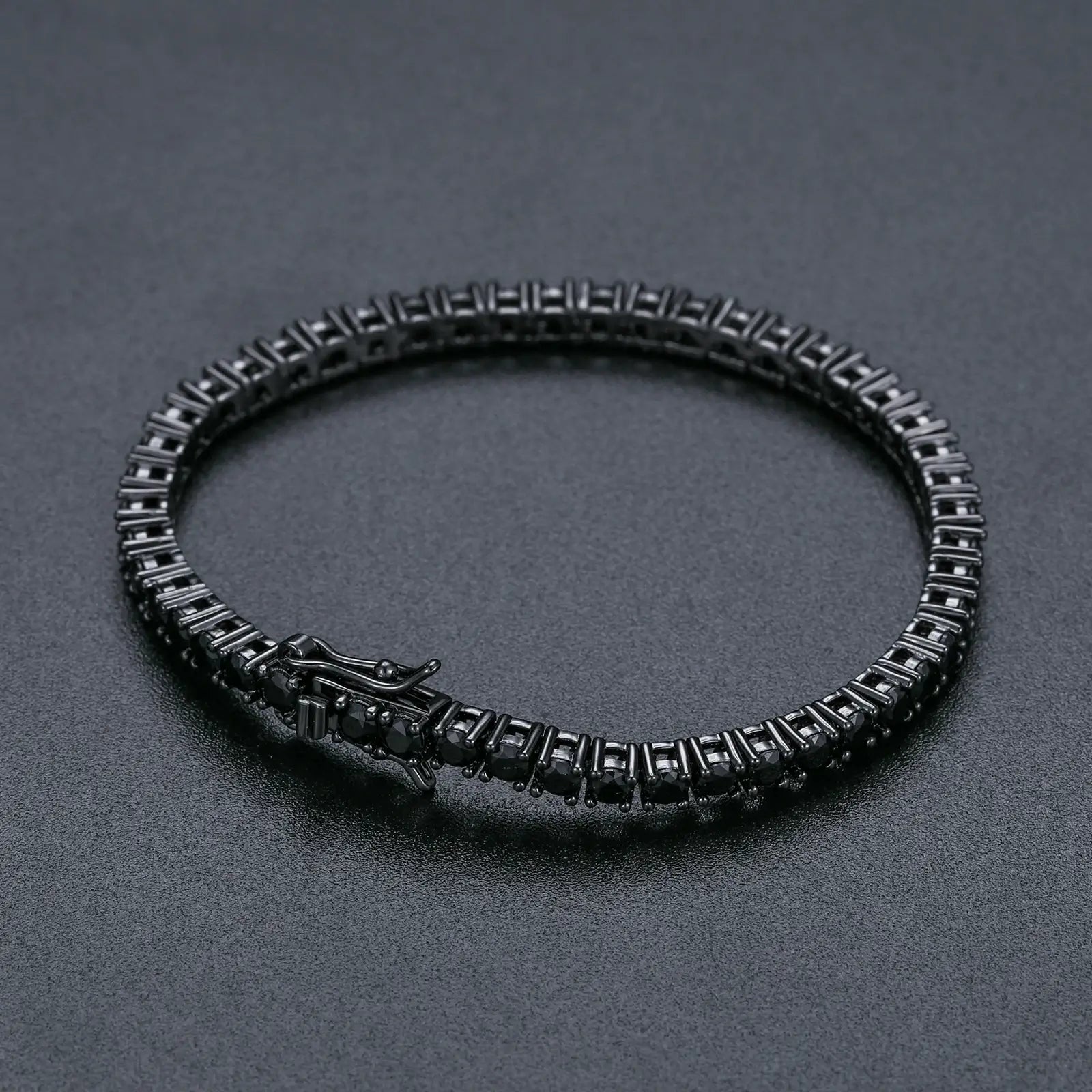 3mm black moissanite tennis bracelet on black table, showcasing sleek 925 sterling silver with black rhodium plating and mysterious gemstone elegance