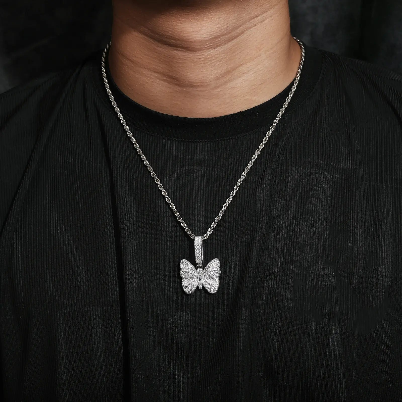 Caucasian man wearing S925 butterfly pendant on rope chain - hypoallergenic moissanite wings | Waterproof spiritual jewelry