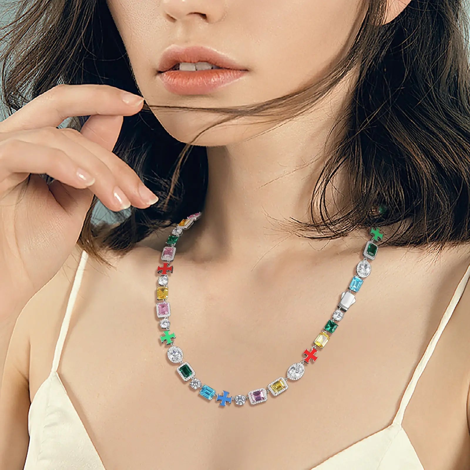 Caucasian model wearing gold tennis chain with colorful enamel crosses - vibrant gemstones and moissanite on S925 silver | Waterproof fashion necklace