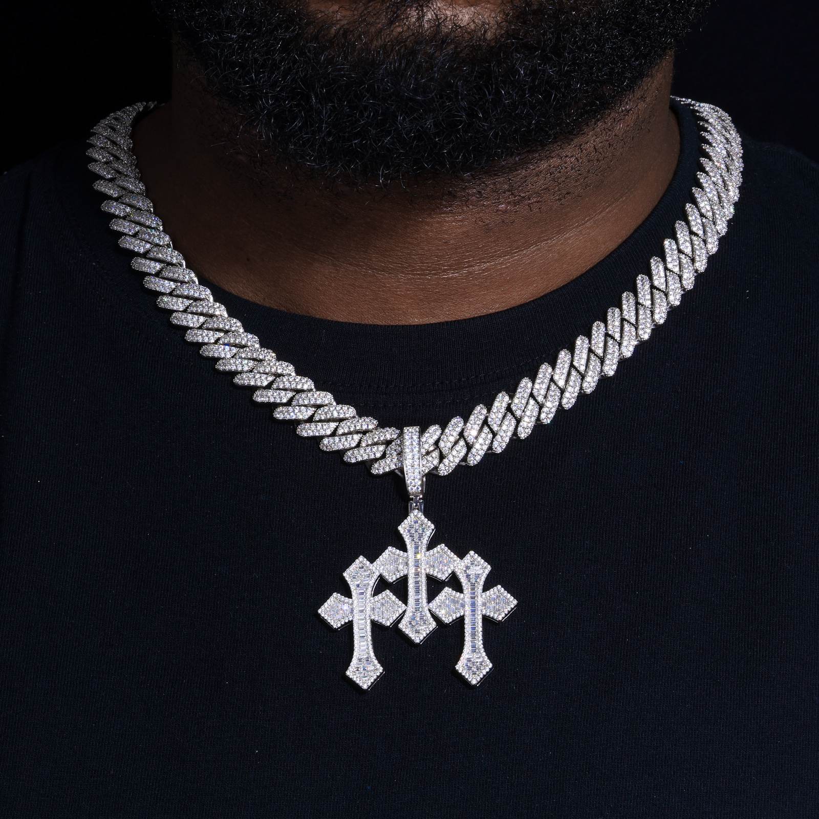 Close-up of 3D stacked cross pendant on female model’s neck, showcasing 24K gold plating and hand-paved moissanite stones under professional studio lighting