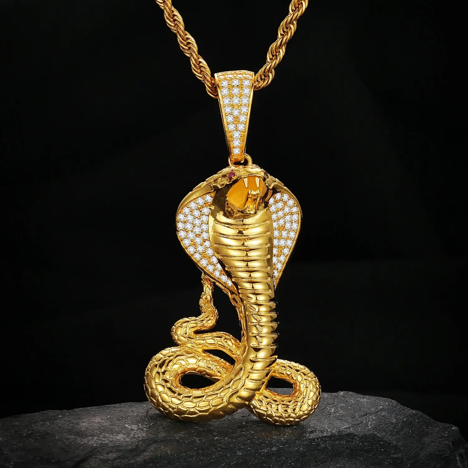 14K gold king cobra pendant hanging vertically on black - moissanite scales with ruby eyes | Luxury men's power jewelry
