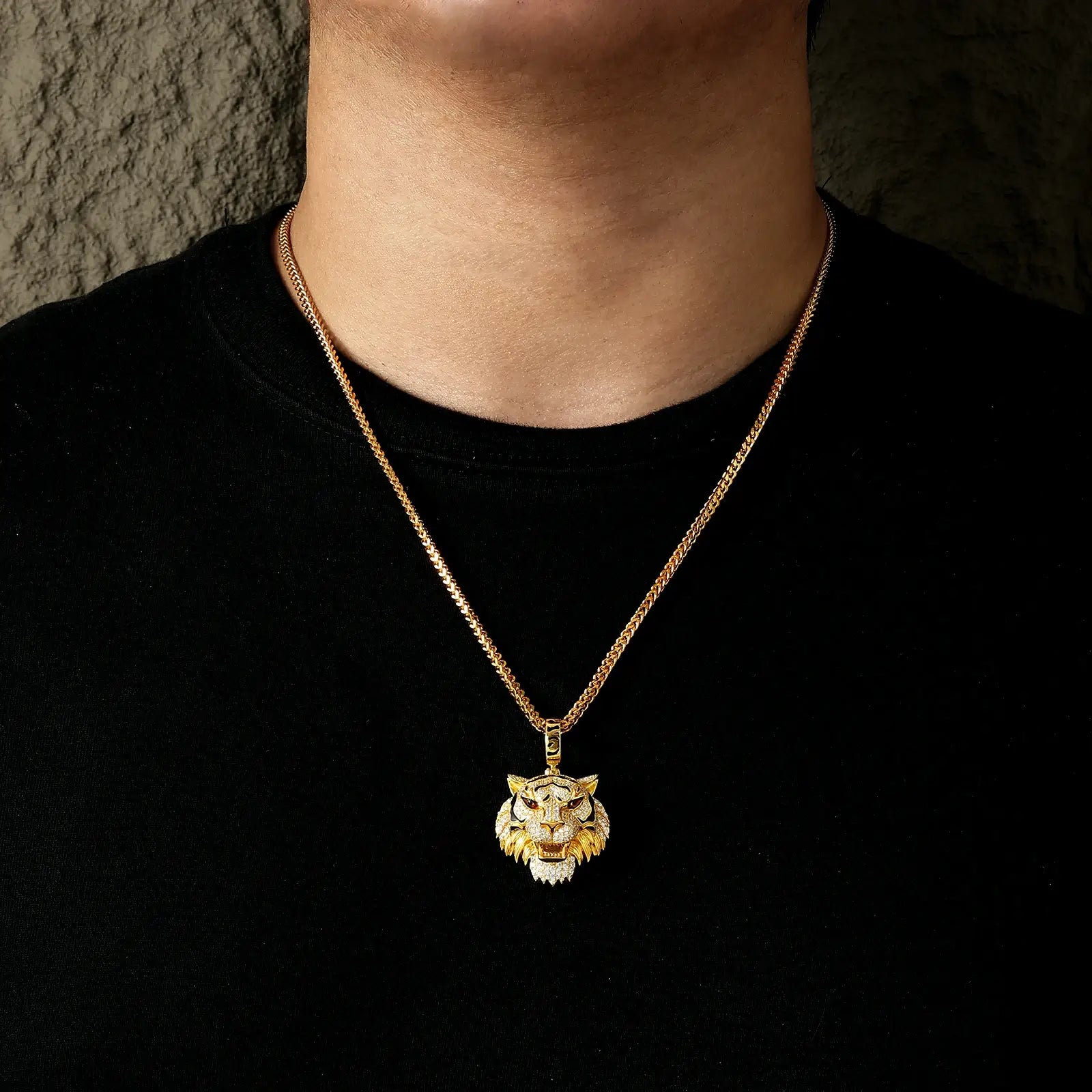 Stylish male model showcasing the gold plated 3D tiger head pendant with VVS moissanite accents in streetwear setting.