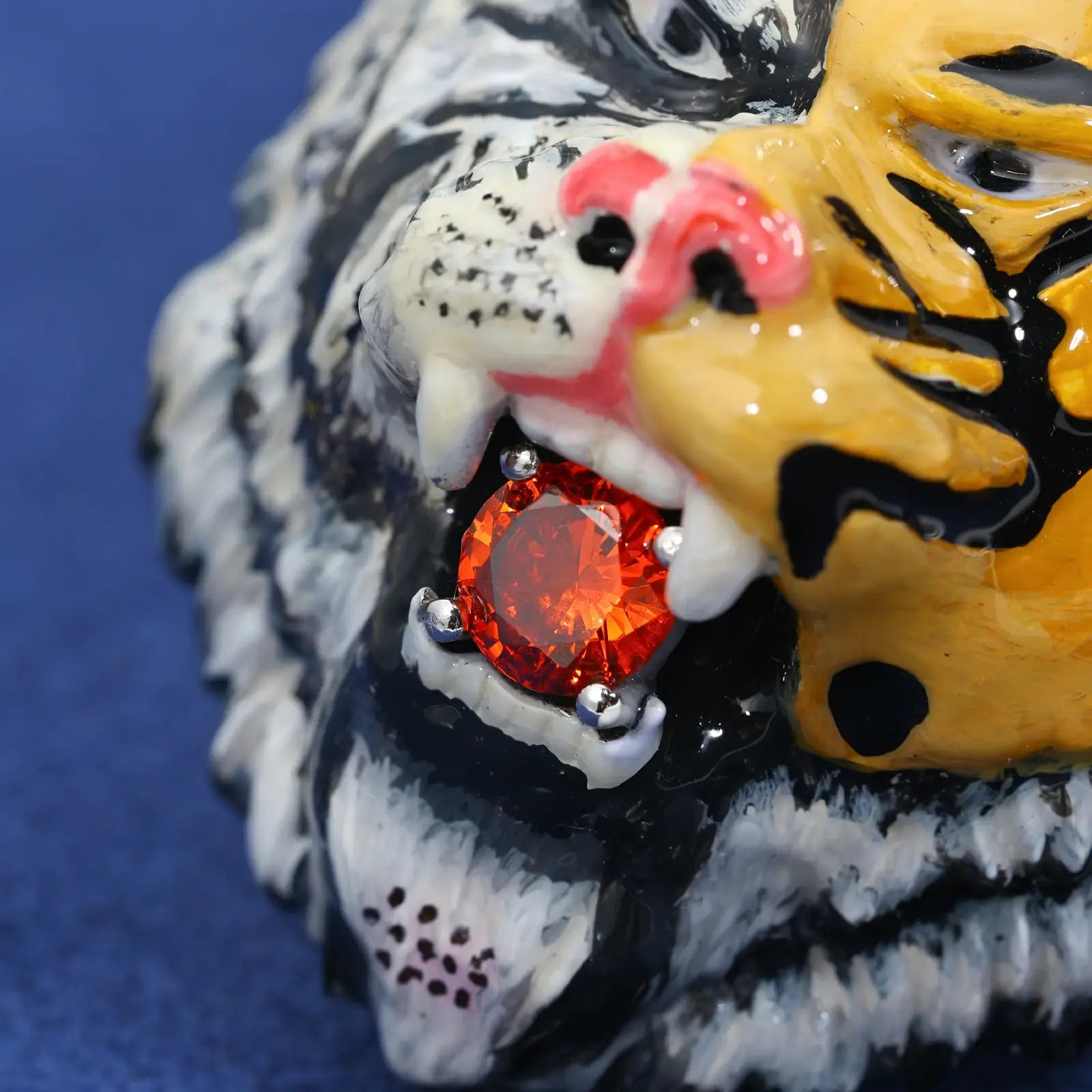 Extreme close-up: Red moissanite tongue detail on tiger pendant - precision prong setting | VVS stone clarity