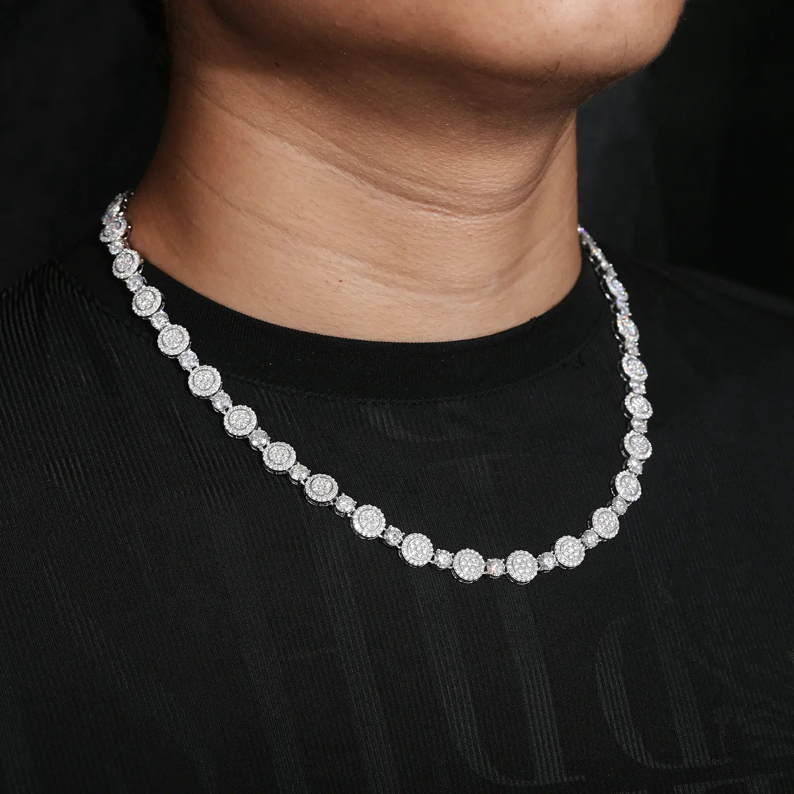Close-up of male model wearing 9mm white gold moissanite tennis chain - hypoallergenic 925 sterling silver with GRA certified stones