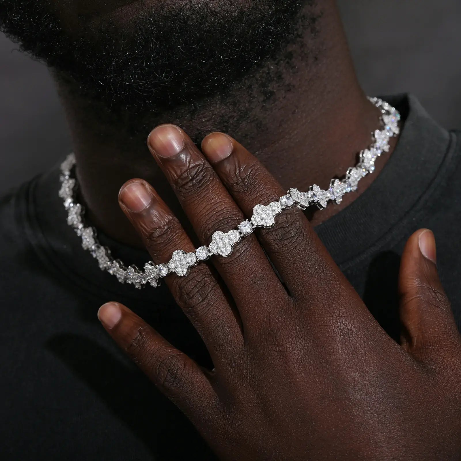 Male model in casual attire wearing 10mm white gold cross tennis chain - 925 sterling silver moissanite jewelry with urban luxury style