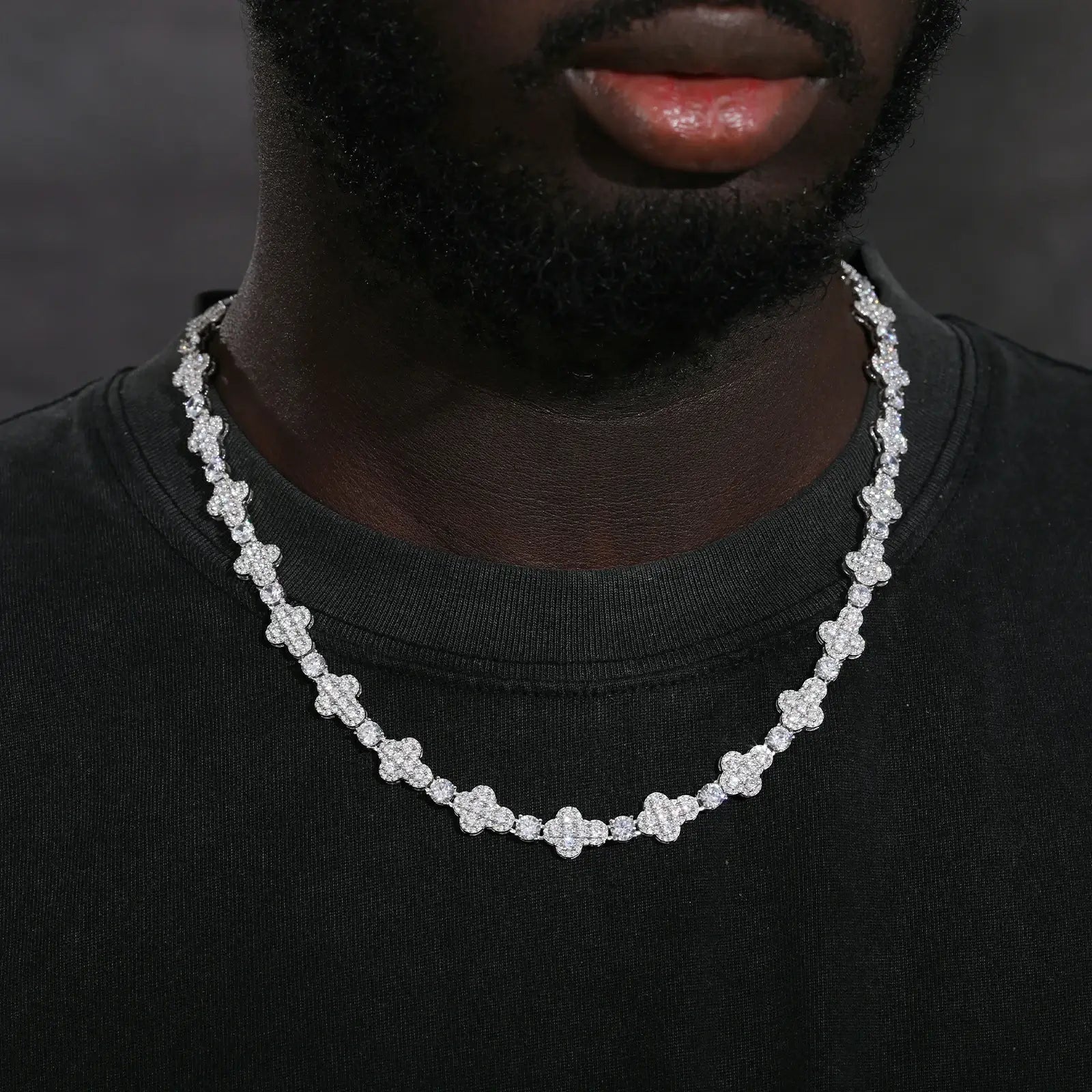 Professional male model in formal wear showcasing 10mm white gold moissanite cross tennis chain - 925 sterling silver luxury jewelry for men