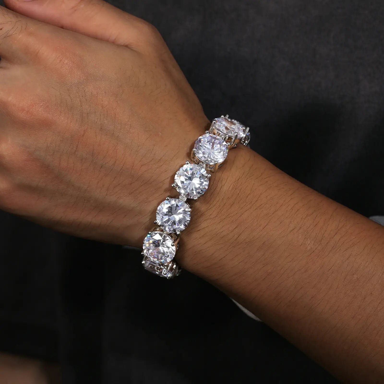 Male model wearing 15mm white gold moissanite tennis bracelet - oversized 925 sterling silver statement jewelry for men with brilliant stones