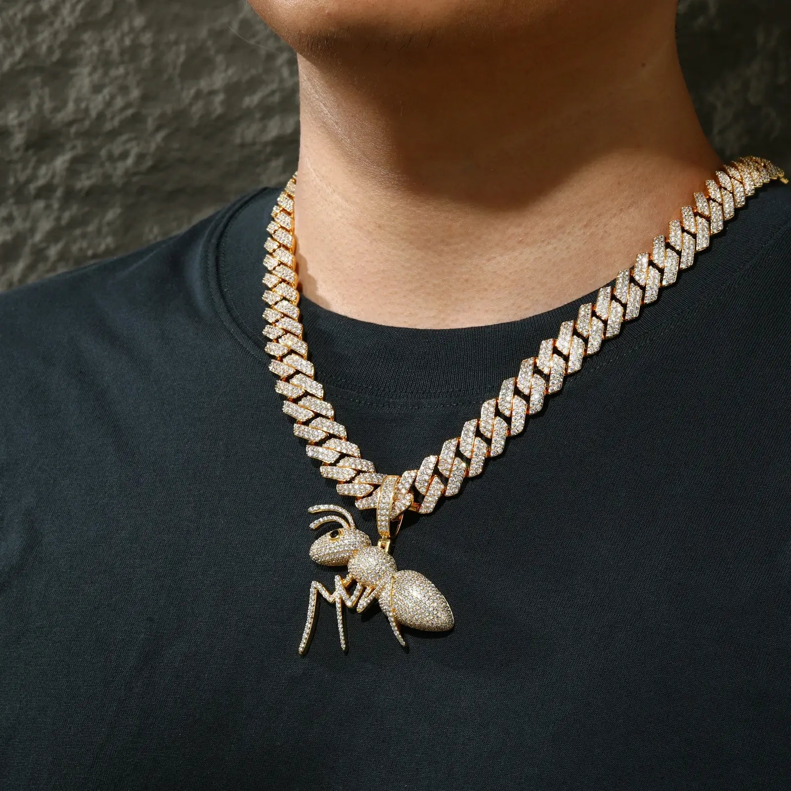 Male model wearing gold plated ant pendant on Cuban chain - 925 sterling silver moissanite jewelry for men with urban luxury style