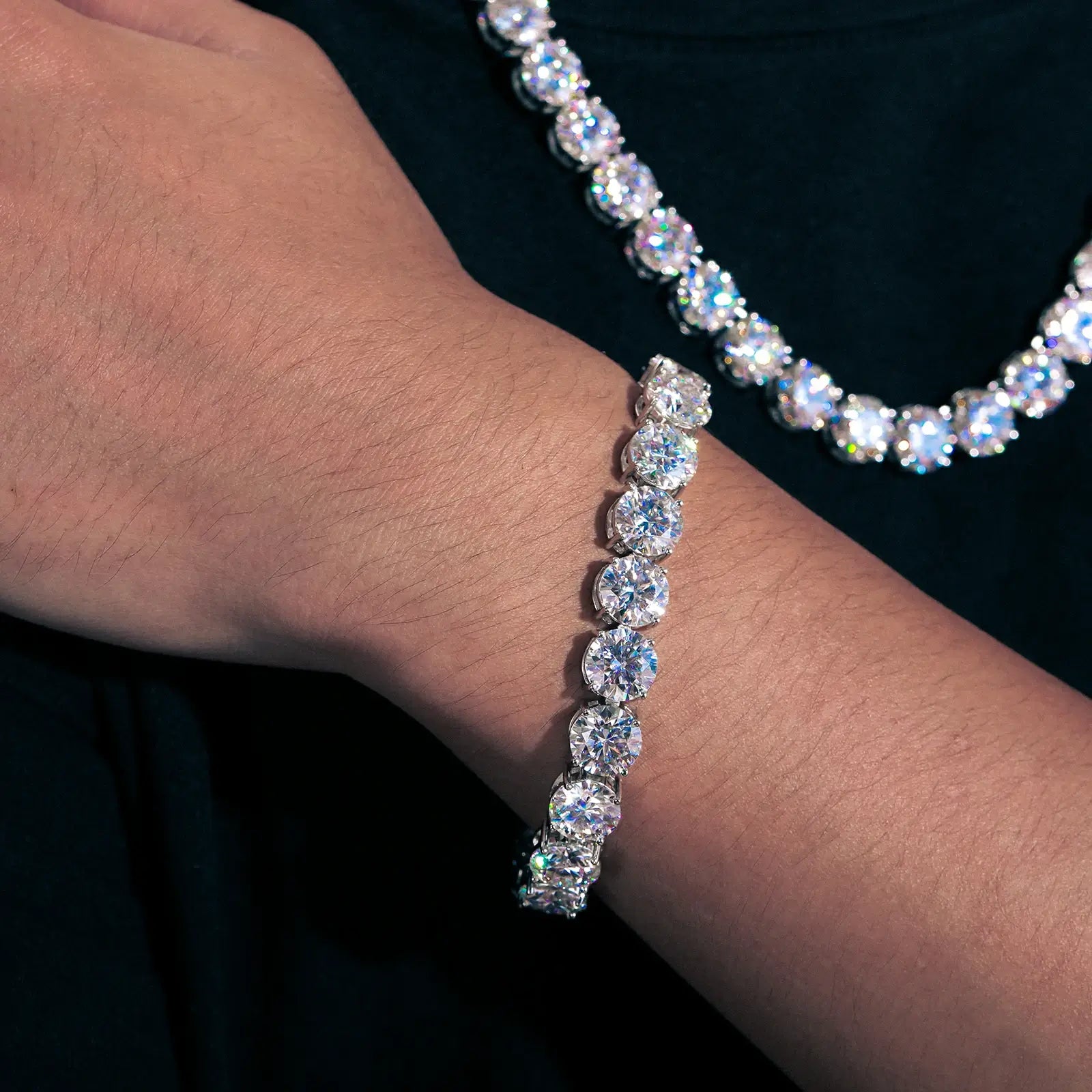 Close-up view of 10mm white gold moissanite tennis bracelet on male wrist, highlighting 11-stone configuration and premium craftsmanship.