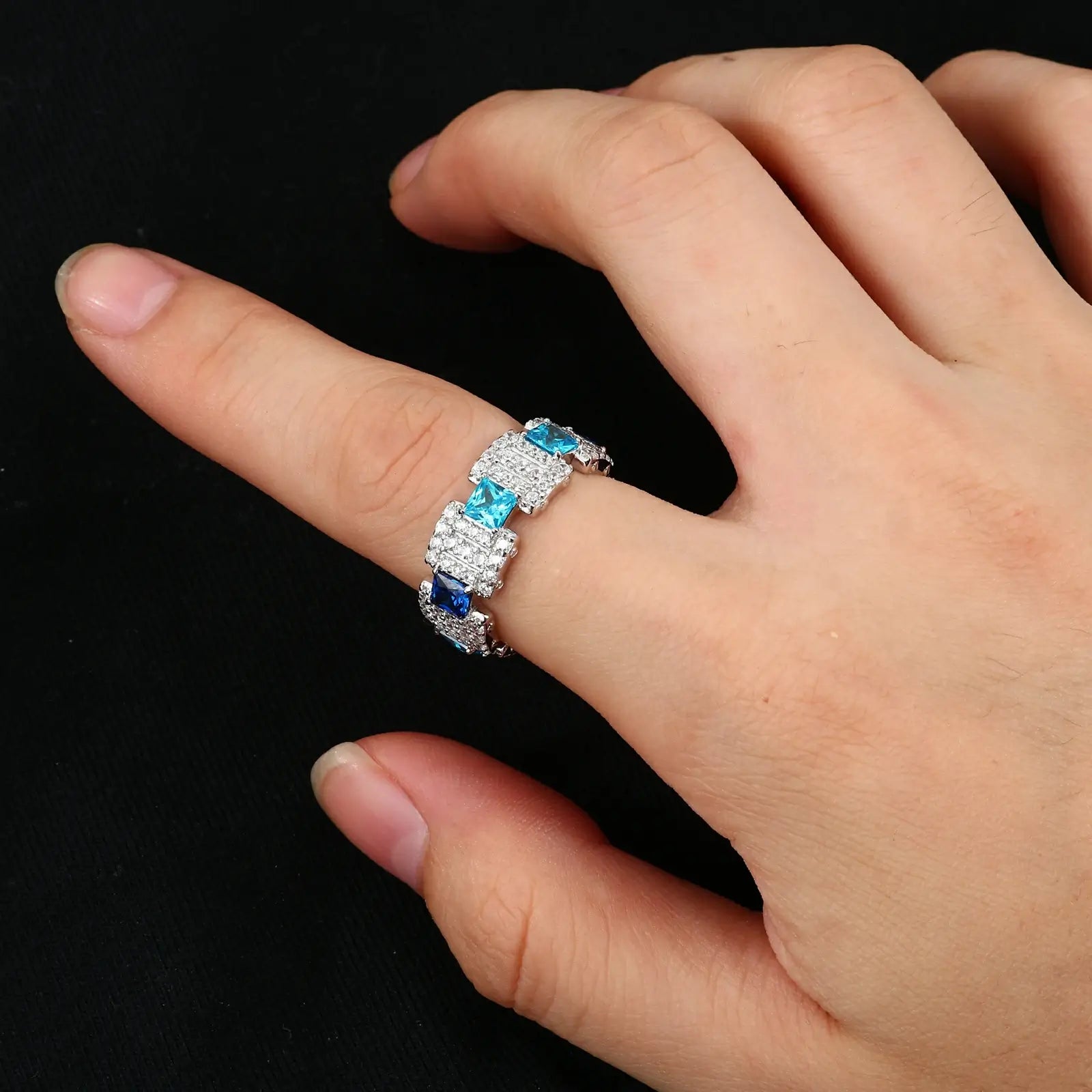 Caucasian man wearing white gold gradient ocean band ring - S925 silver with moissanite waves | Men's waterproof statement jewelry