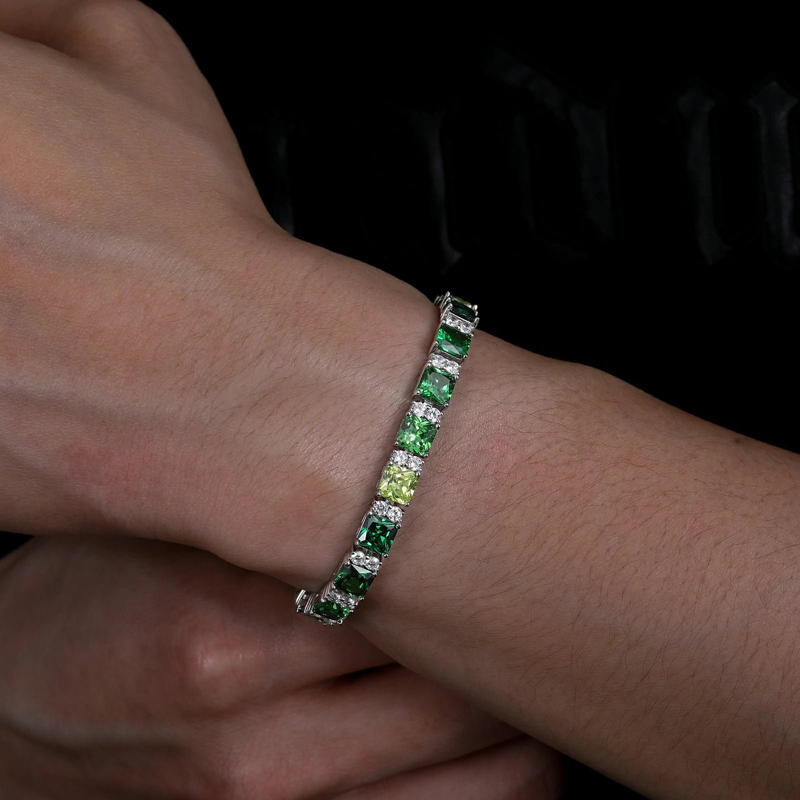 Male wrist wearing 7mm white gold tennis bracelet - gradient emerald green Asscher moissanites evoking Emerald City magic | Luxury S925 men's jewelry
