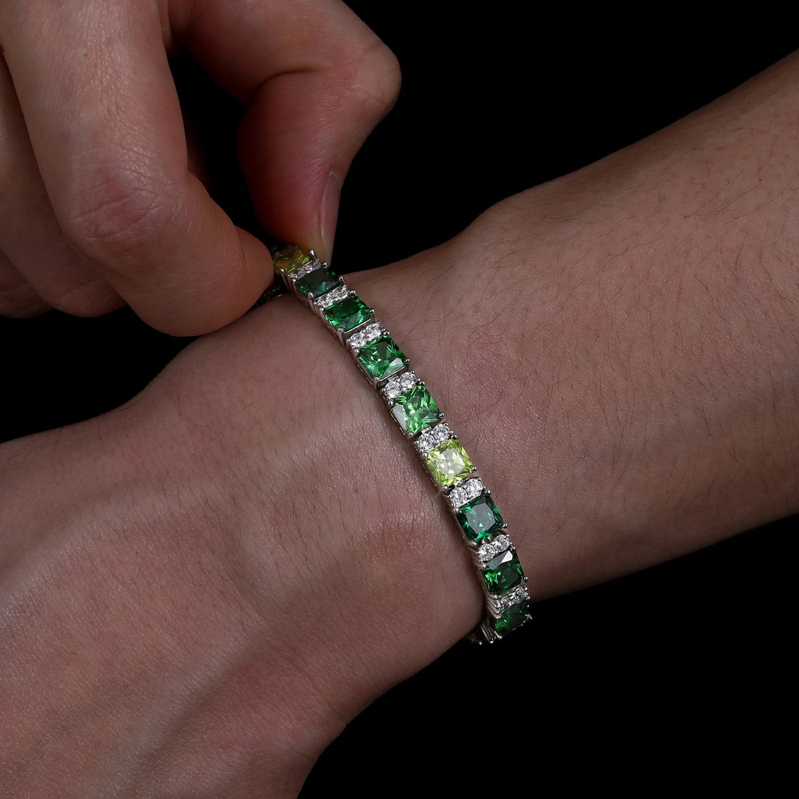 Male model stacking Wizard of Oz bracelet with watch - emerald-to-forest green gradient stones in Asscher cut | Hypoallergenic S925 silver