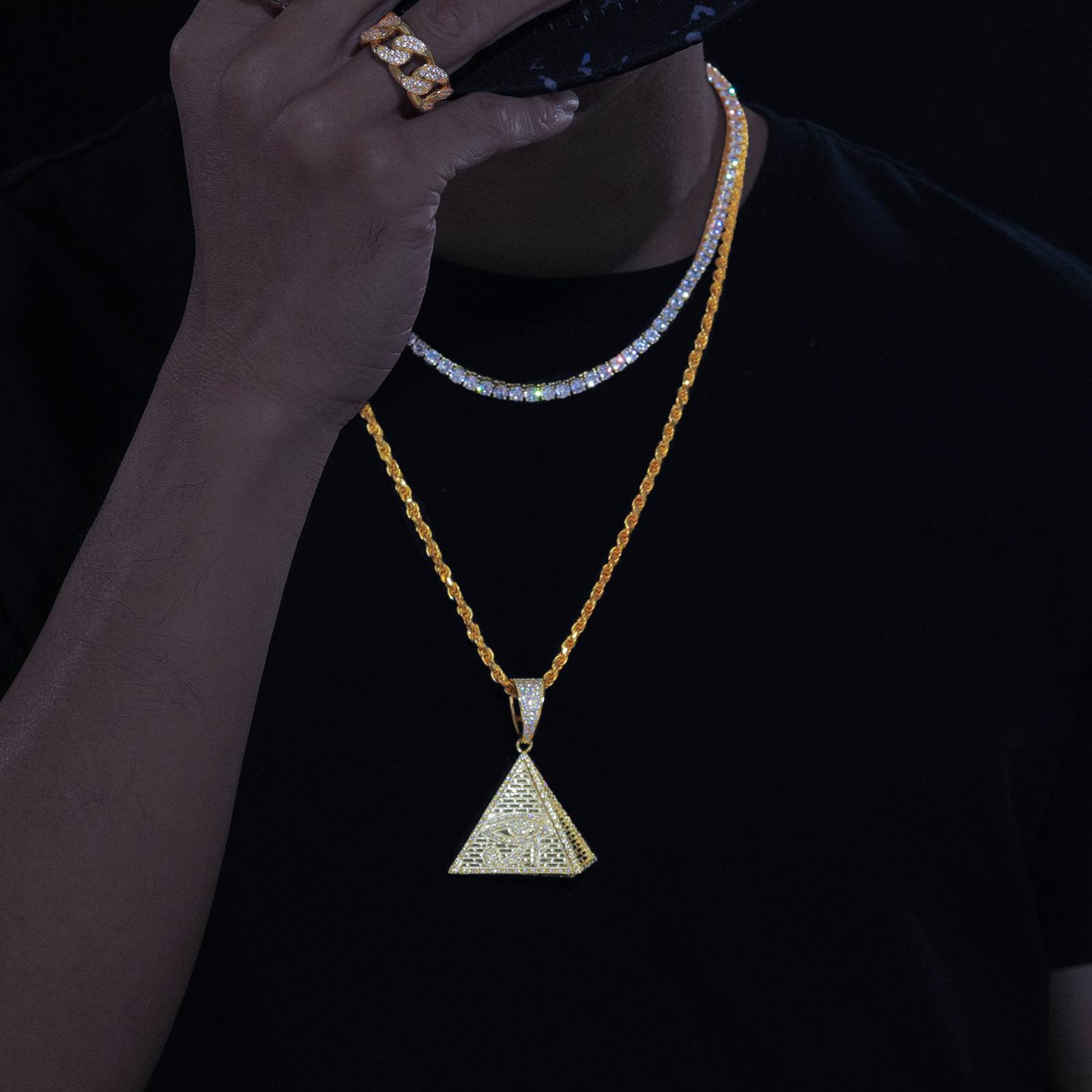 Street influencer wearing gold pyramid pendant on twisted chain - lab-grown moissanite outshining diamonds | Salt-spray tested waterproof core
