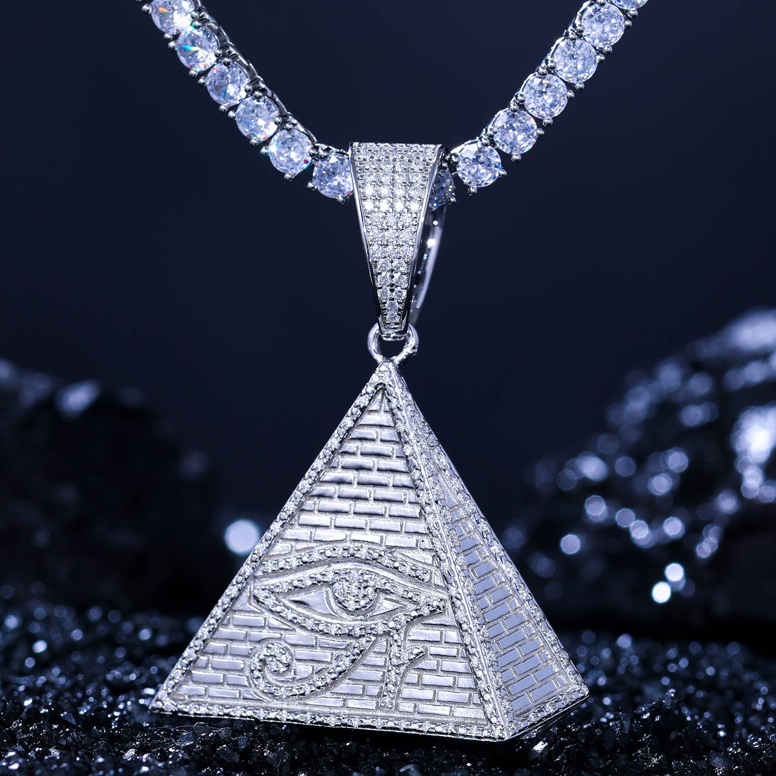 S925 pyramid pendant leaning on black marble - geometric evil eye pattern with VVS moissanites blazing 2.65 RI fire | Ancient protection geometry